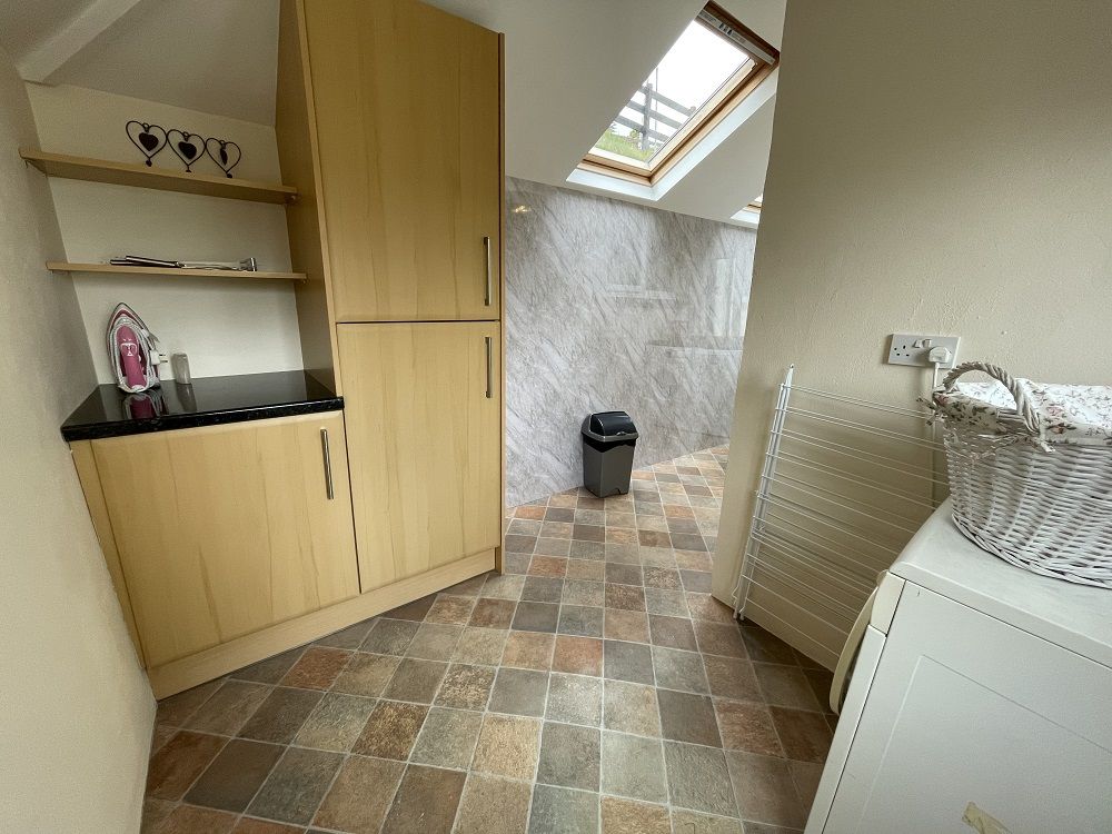 Off the kitchen there is a useful utility area