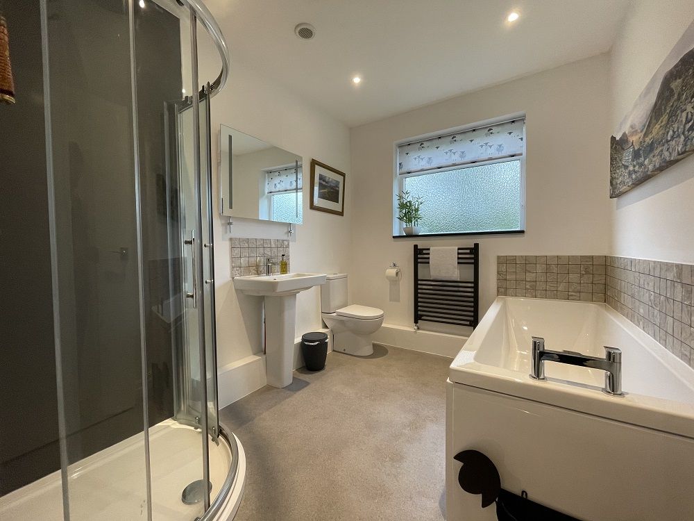 The modern family bathroom features a bath, which is great for families with children and for weary walkers!