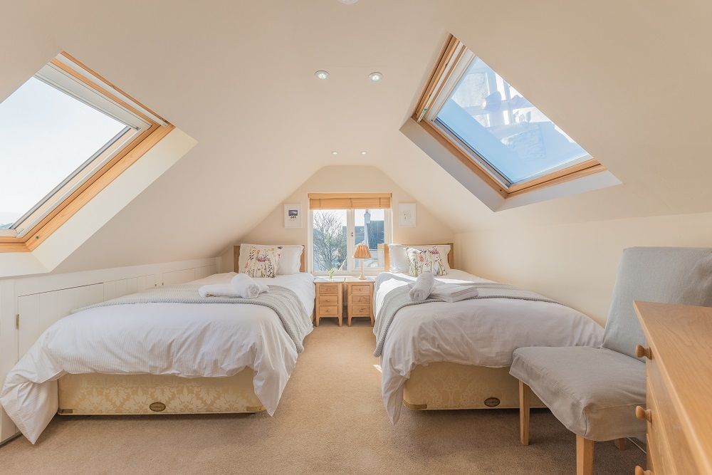 The lovely twin bedroom upstairs enjoys garden views 