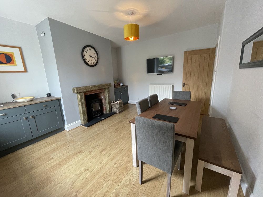 The good sized dining room also features a log burning stove