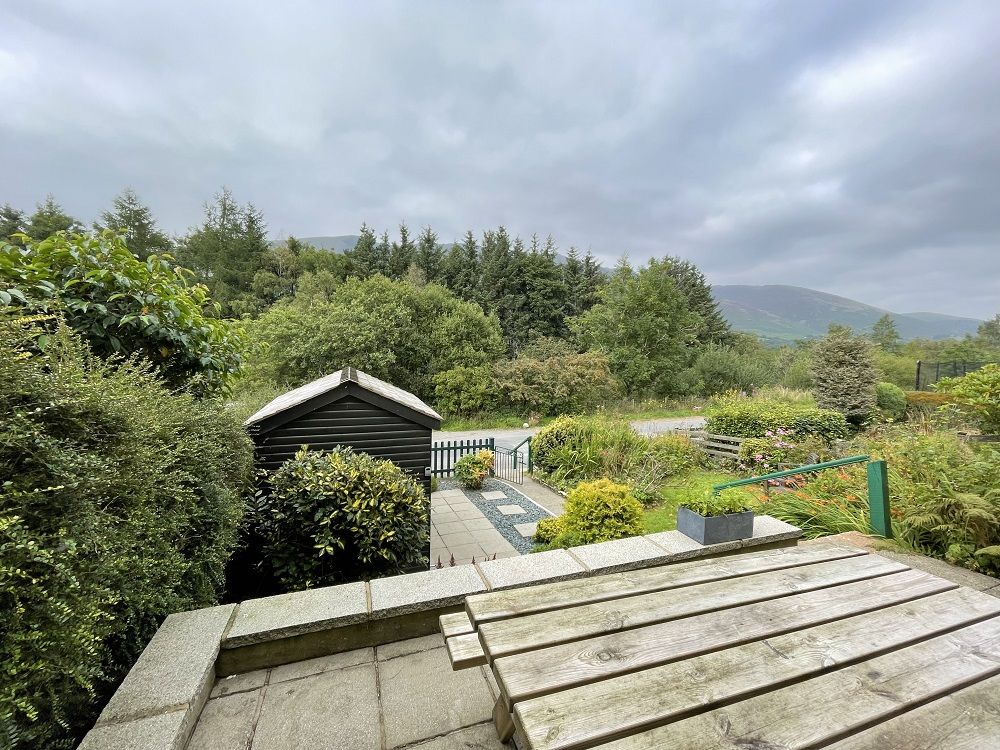 To the front of the property is a beautiful split level garden with patio and seating area