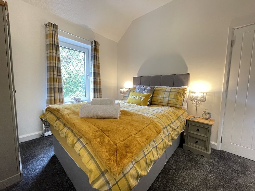 The master bedroom has lovely green views of the trees, with River Greta and Fitz Park beyond