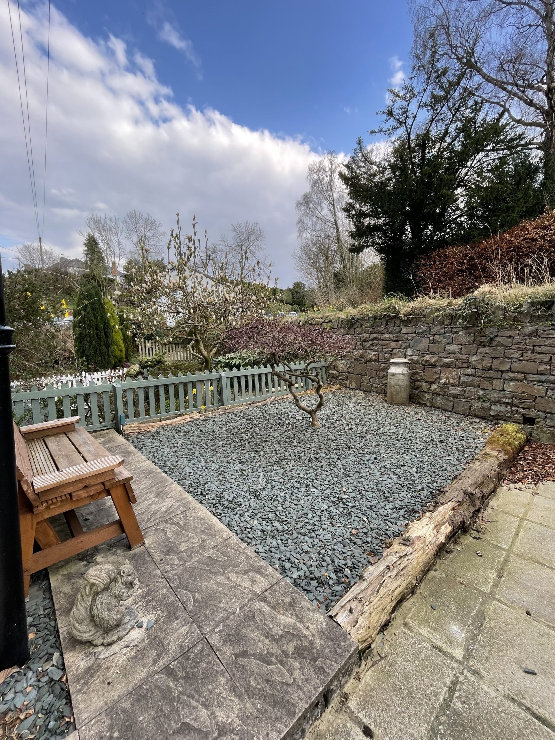 At the front of the property is a garden and seating area