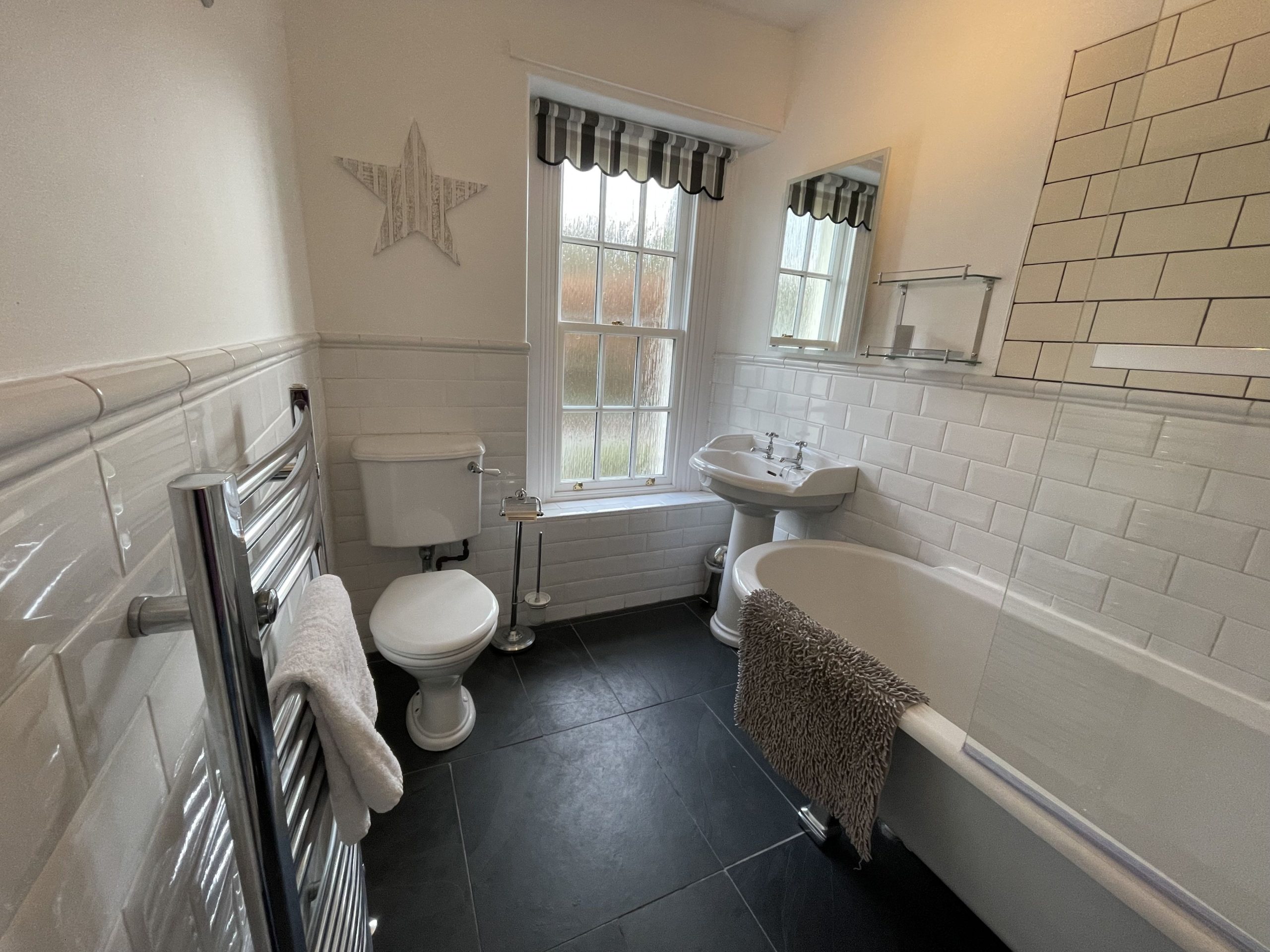The lovely bathroom is found at the front of the property