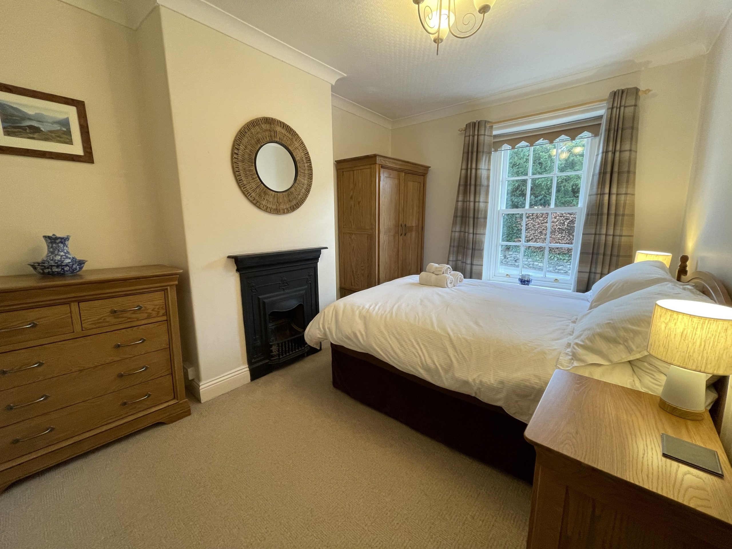 The spacious master bedroom features a double bed and solid oak furniture