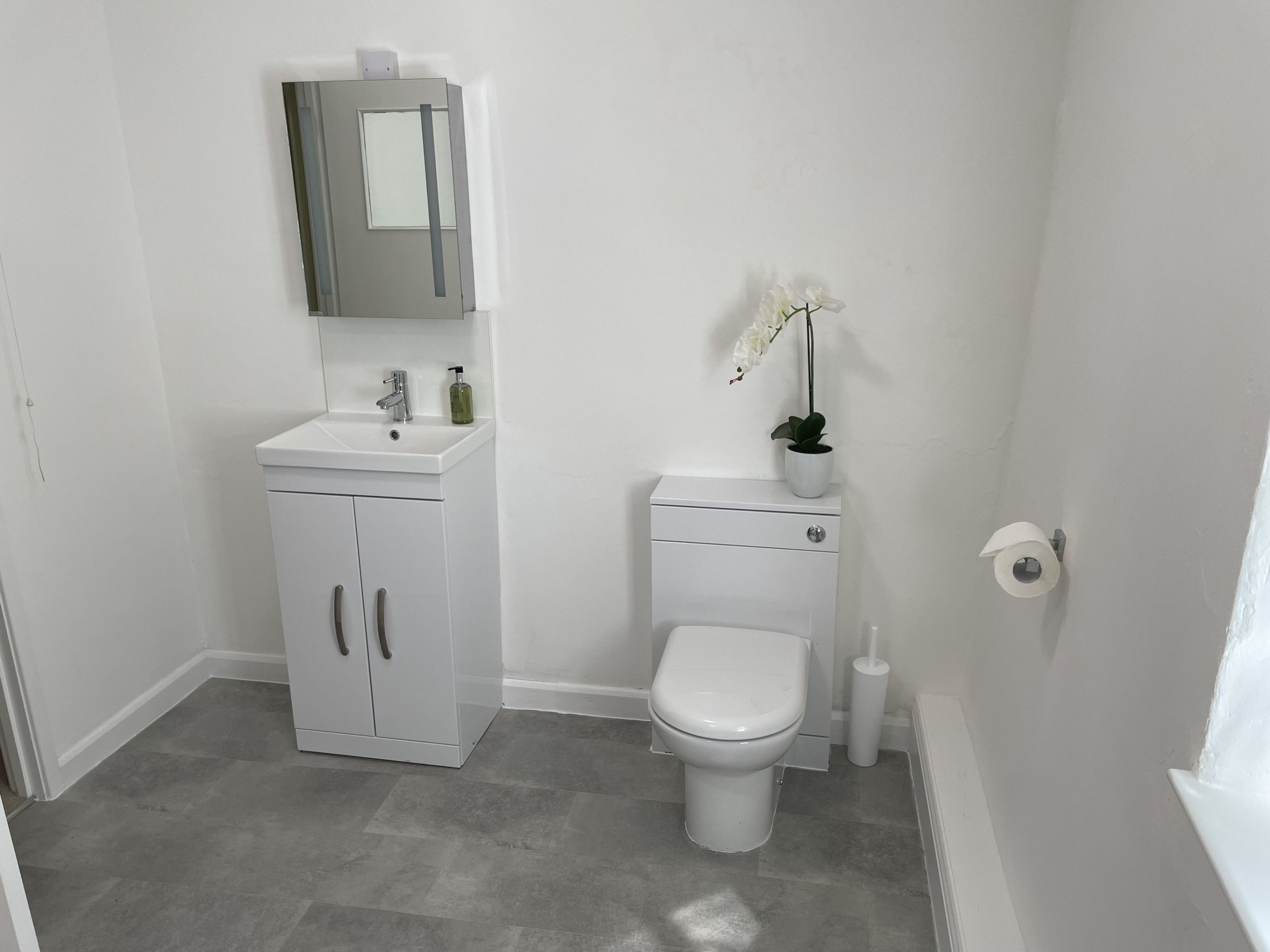 The modern bathroom is spacious and light