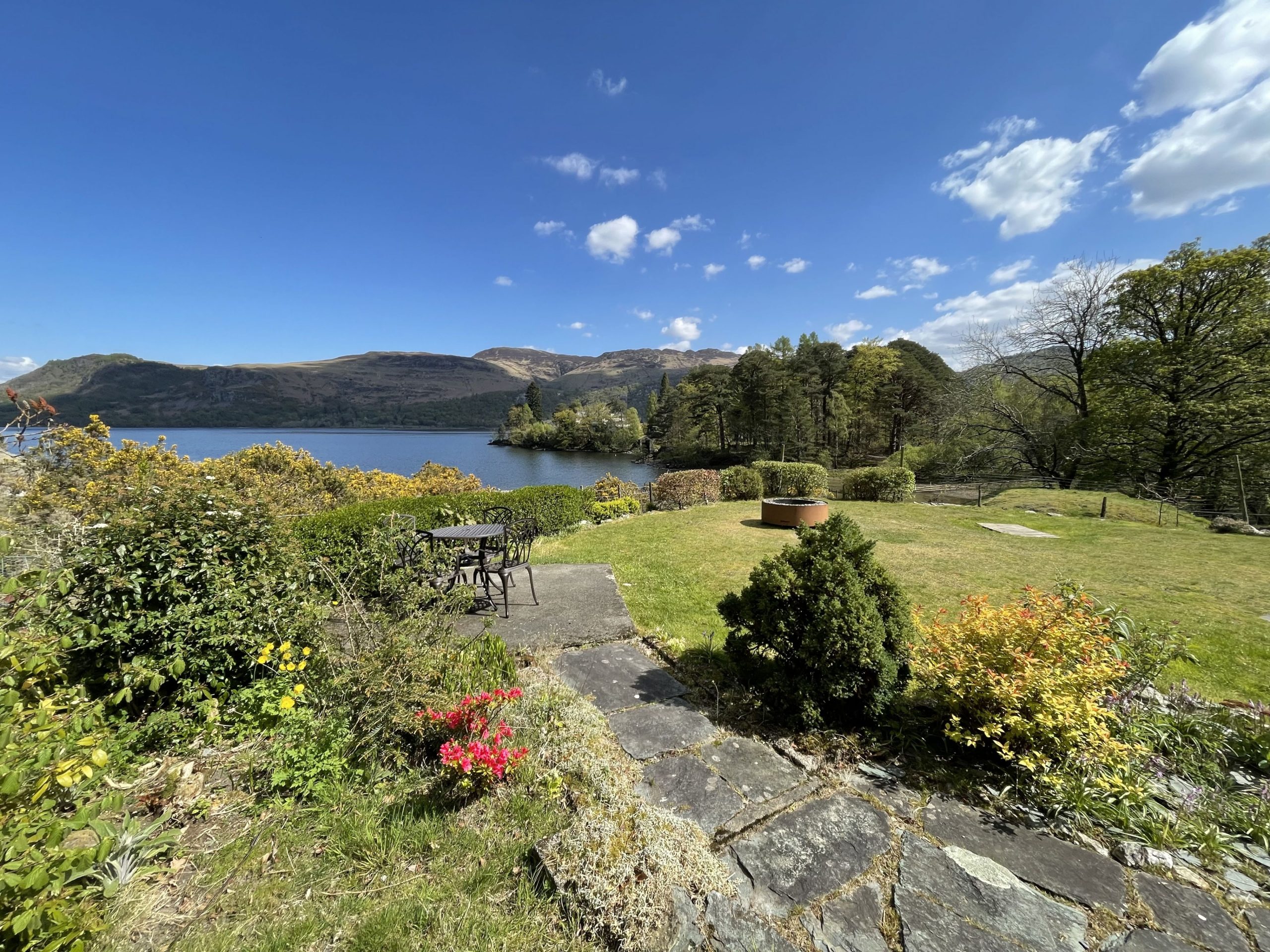Exit the house from the front porch and follow the path down to the small seating area and fire pit