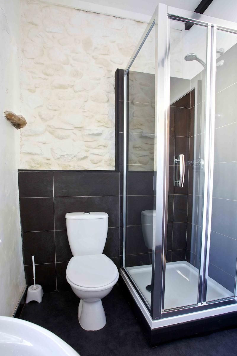 The first floor bathroom has a walk in shower, toilet, sink and heated towel rail