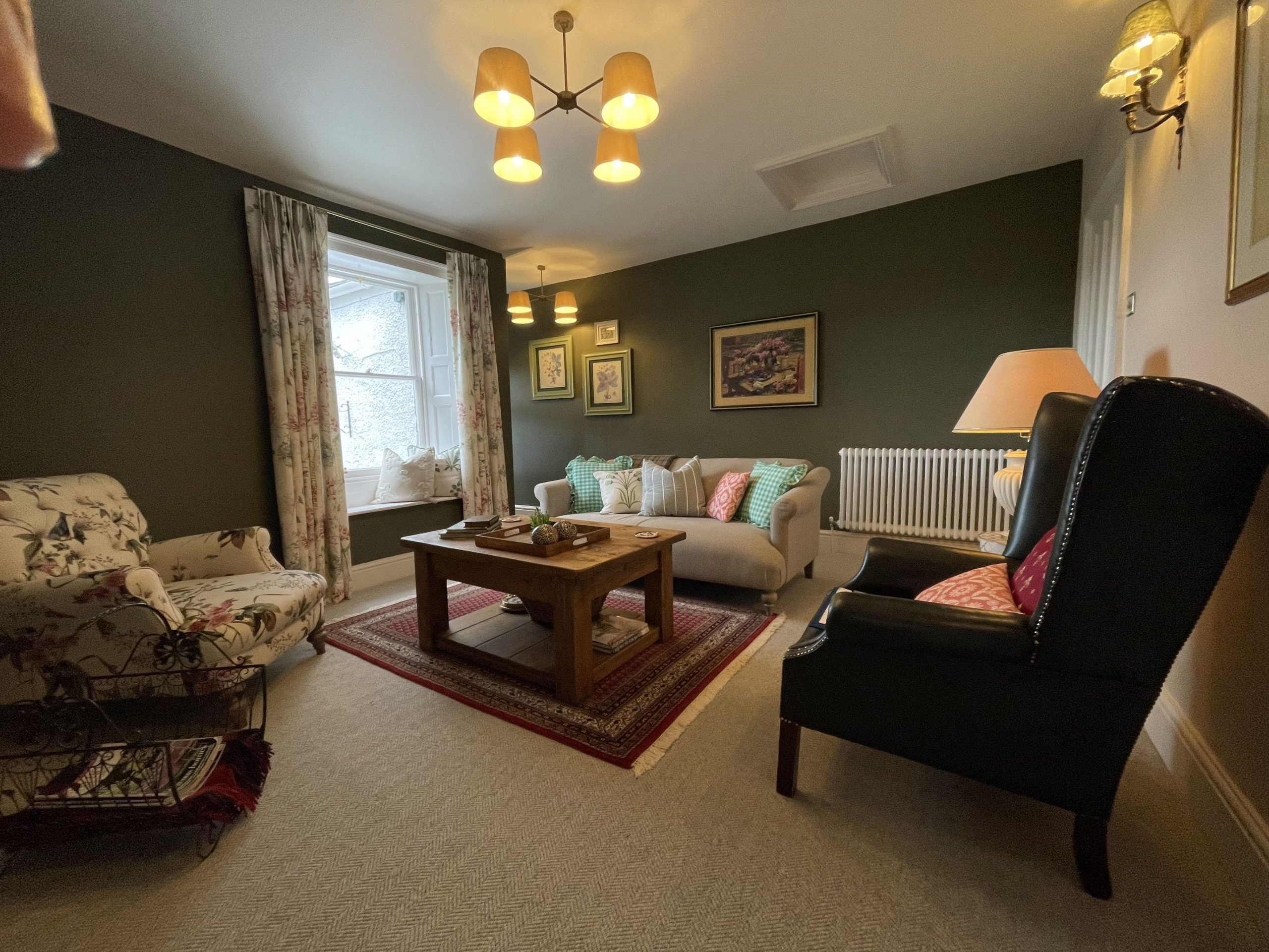 The living room has views over the garden and towards the fells 