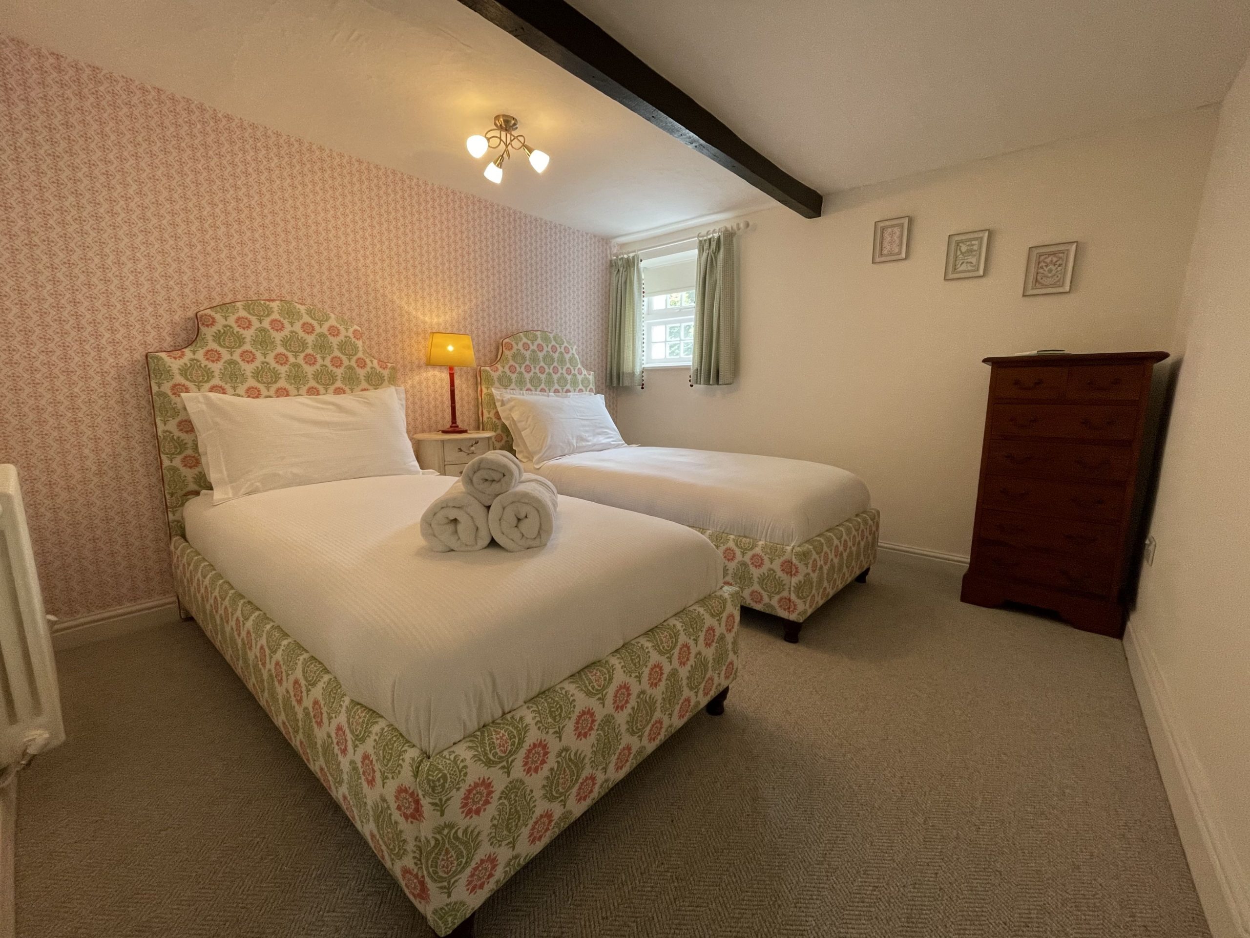 The second bedroom is furnished with 2 single beds