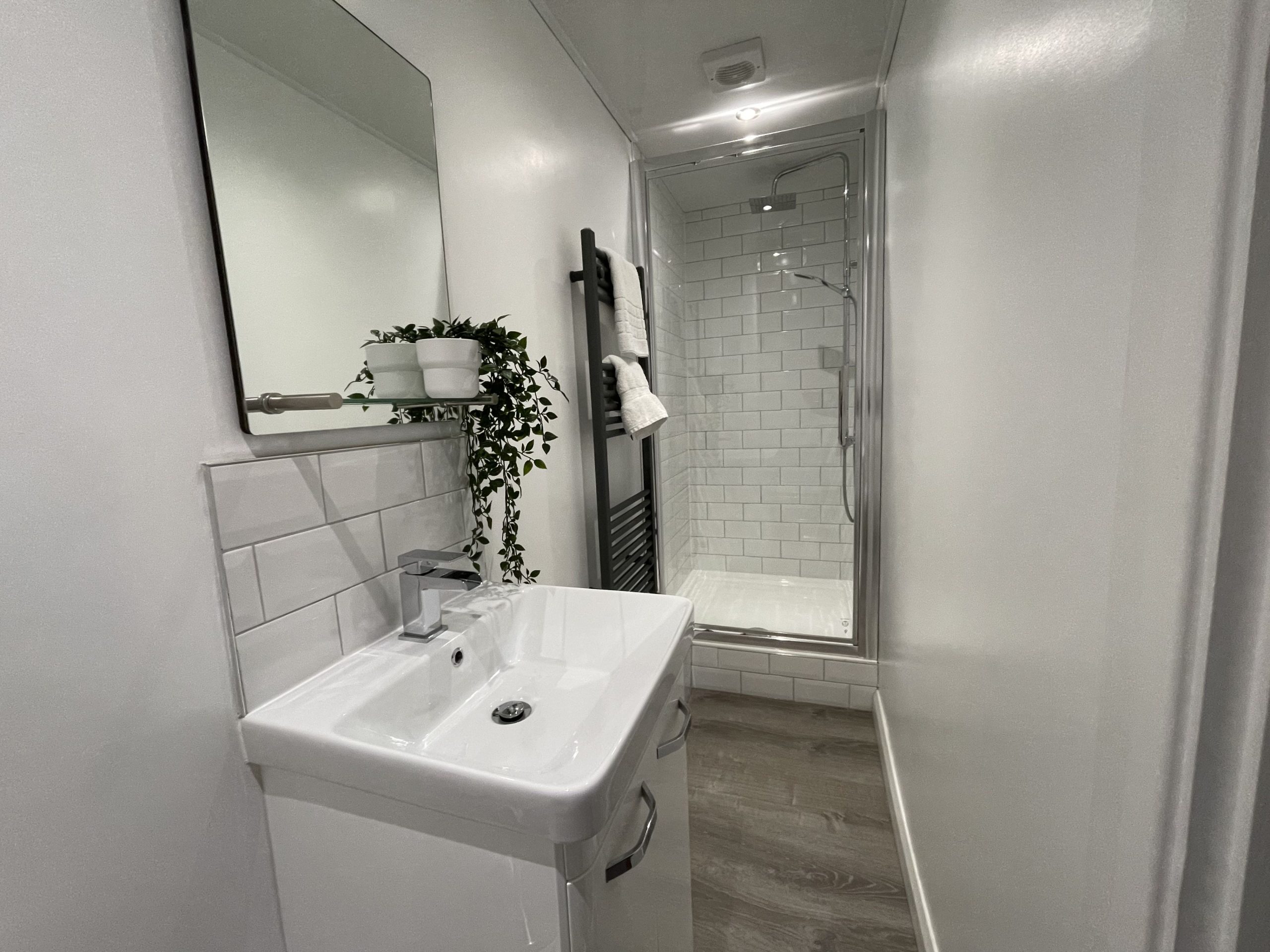 The shower room has a similar style to the family bathroom