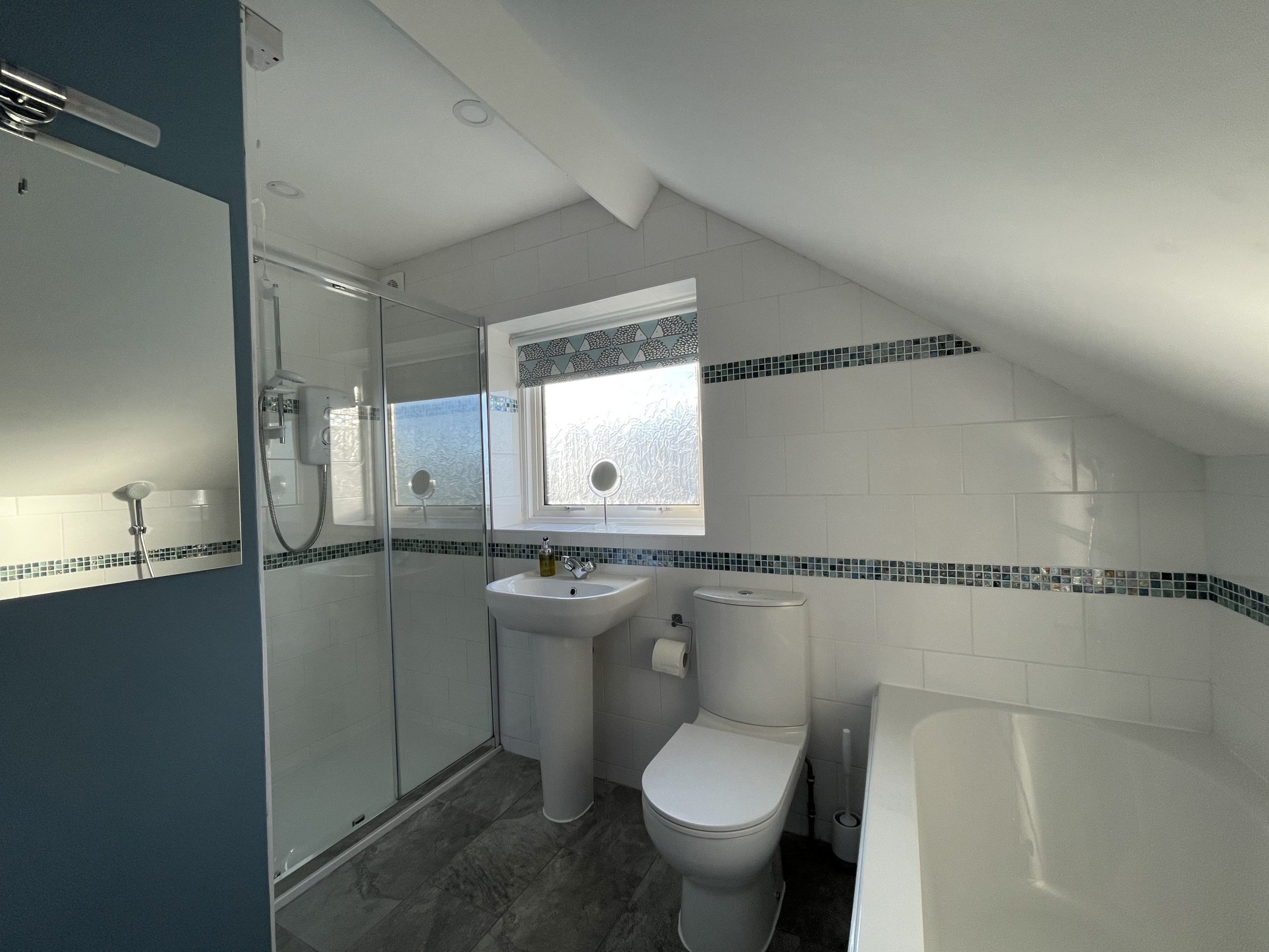 The bathroom comprises a bath and separate shower, WC and hand sink