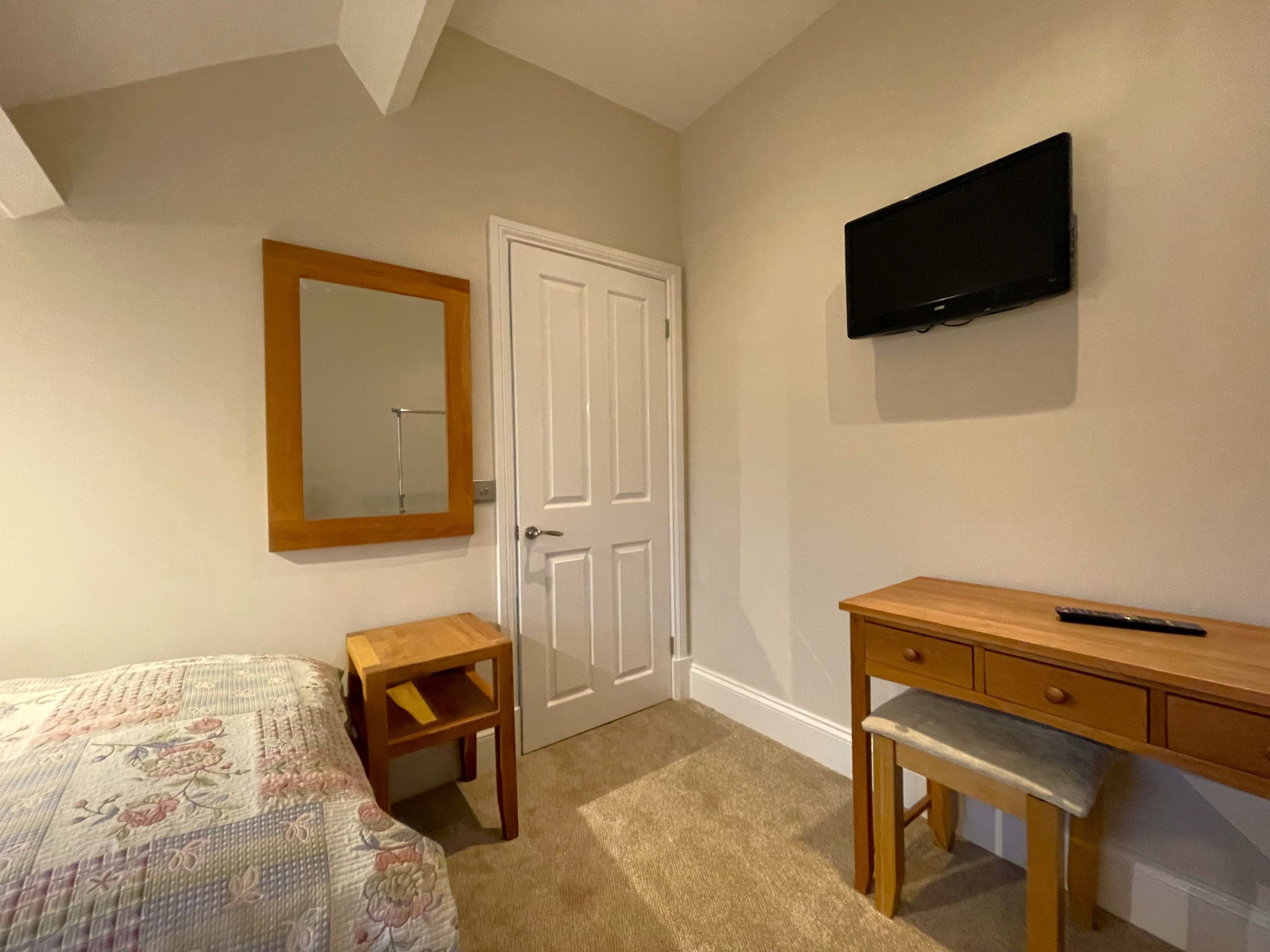 A wall mounted TV and dressing table are also provided