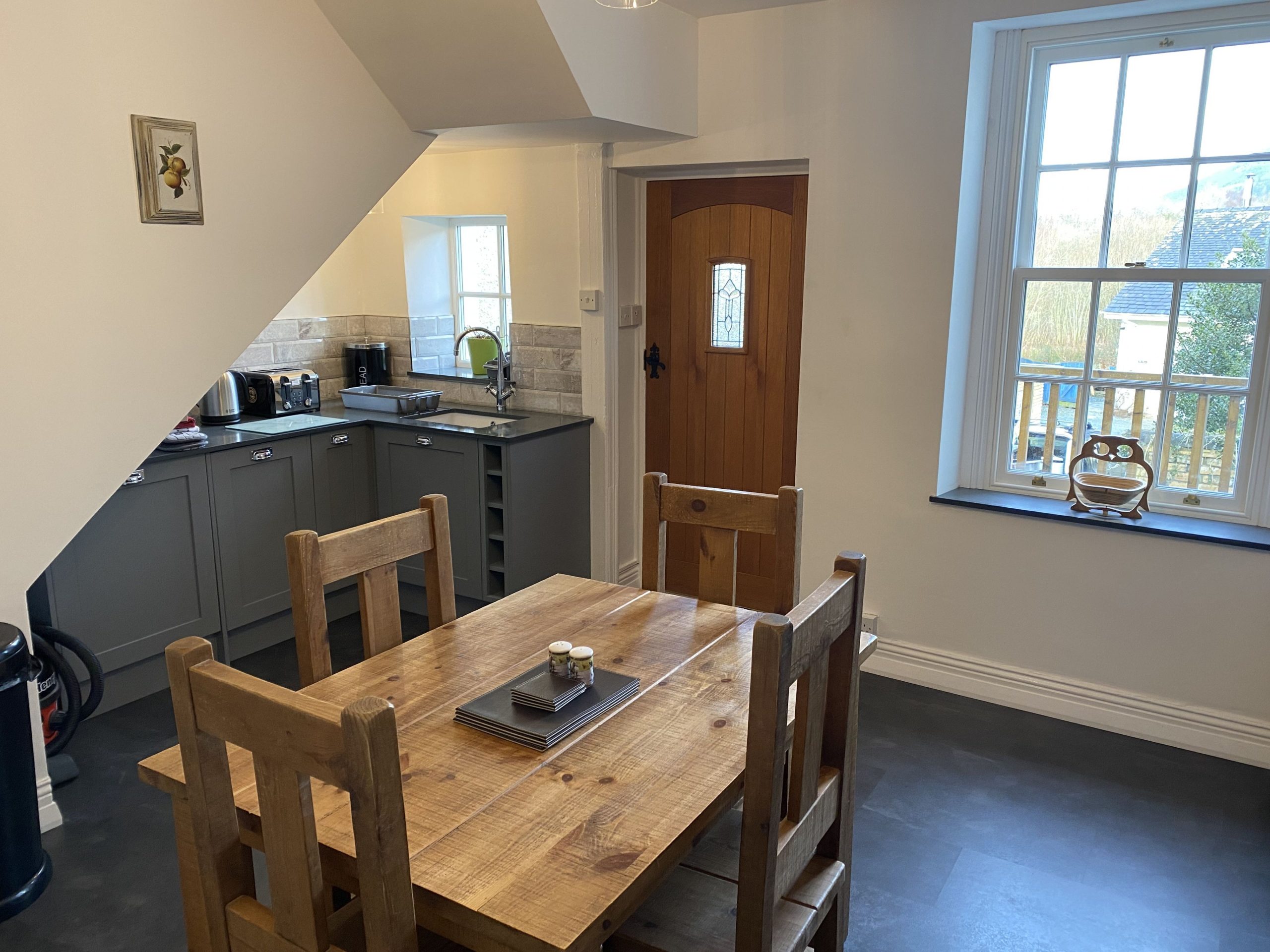 The spacious kitchen features a dining table which comfortably seats 4 people