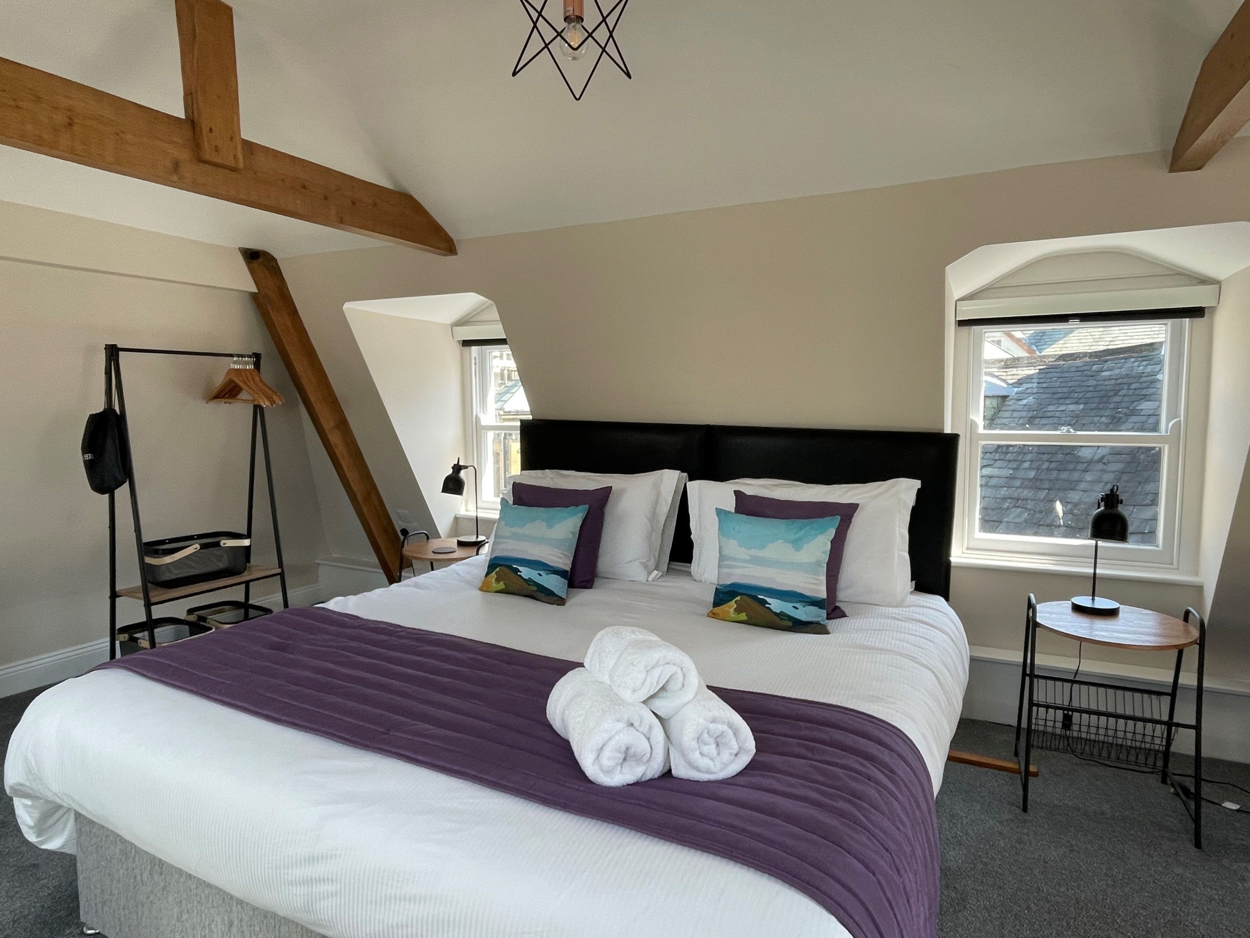 The bedroom also has a tub armchair, storage and full length mirror