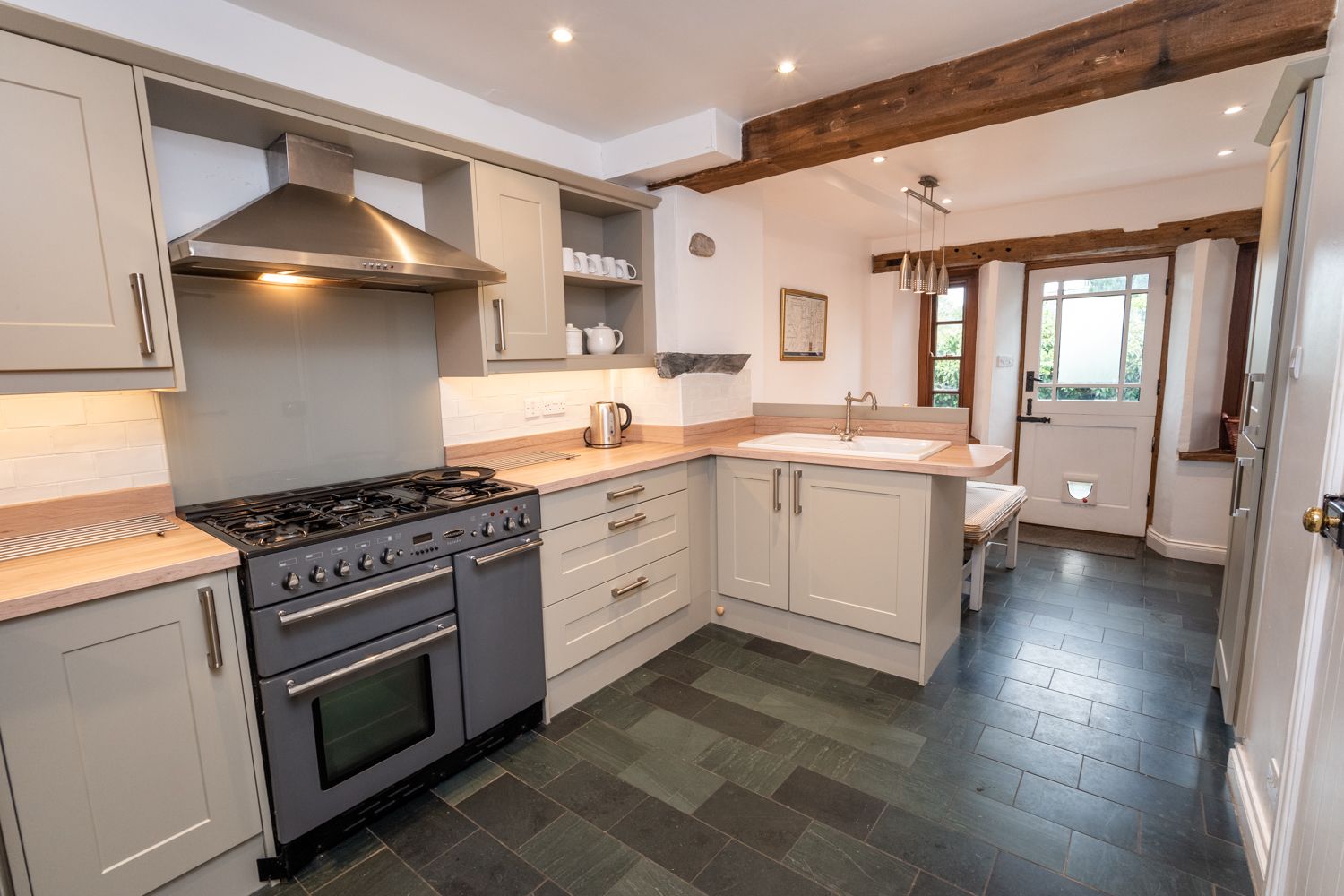 A lovely spacious kitchen and dining area with access to the rear patio and parking spaces