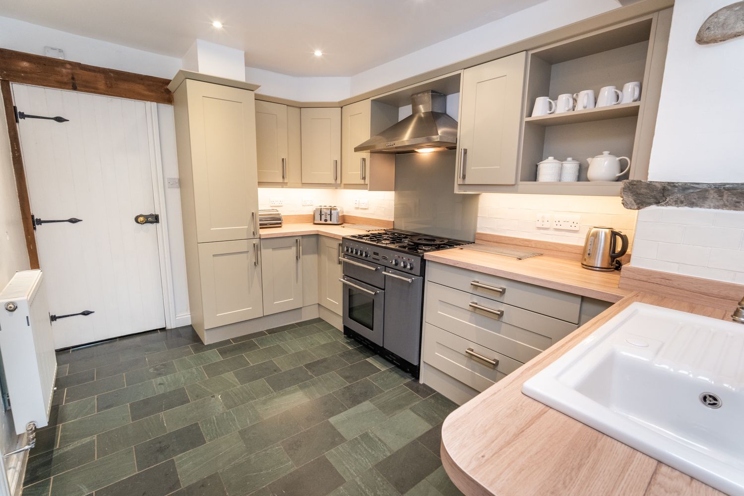 The kitchen has an impressive gas range, oven, dishwasher, fridge/freezer and microwave