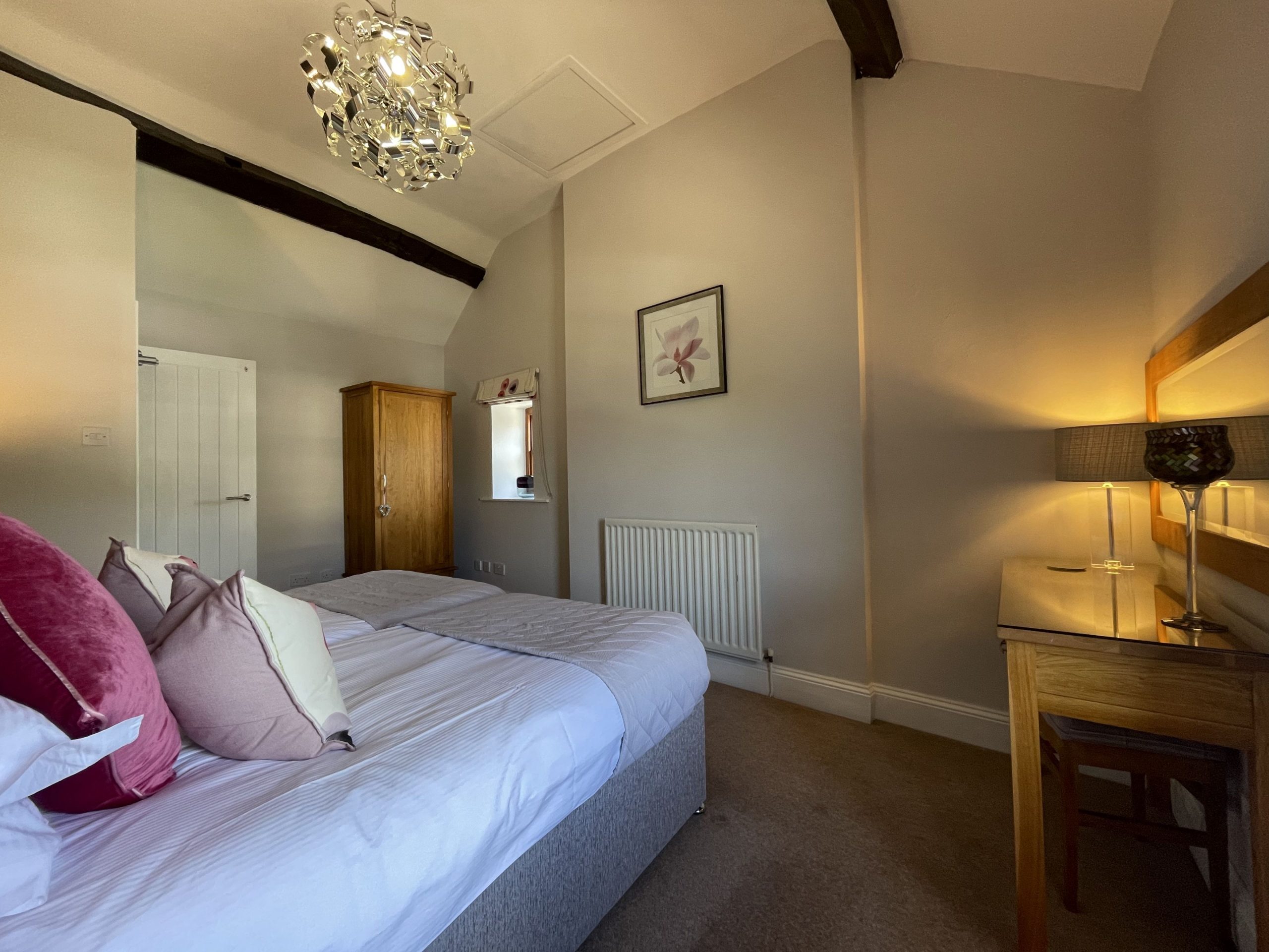 The bedroom enjoys high ceilings and original features