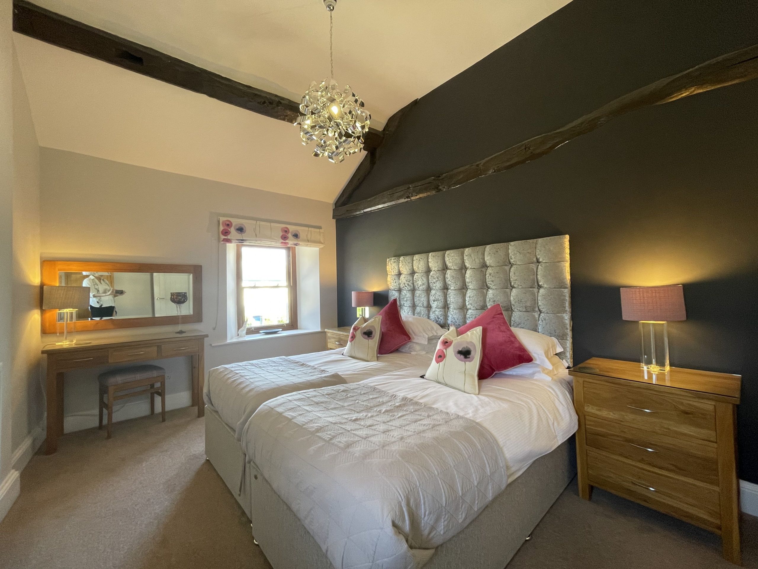 The twin bedroom is also furnished with a wardrobe, bedside tables and a dressing table