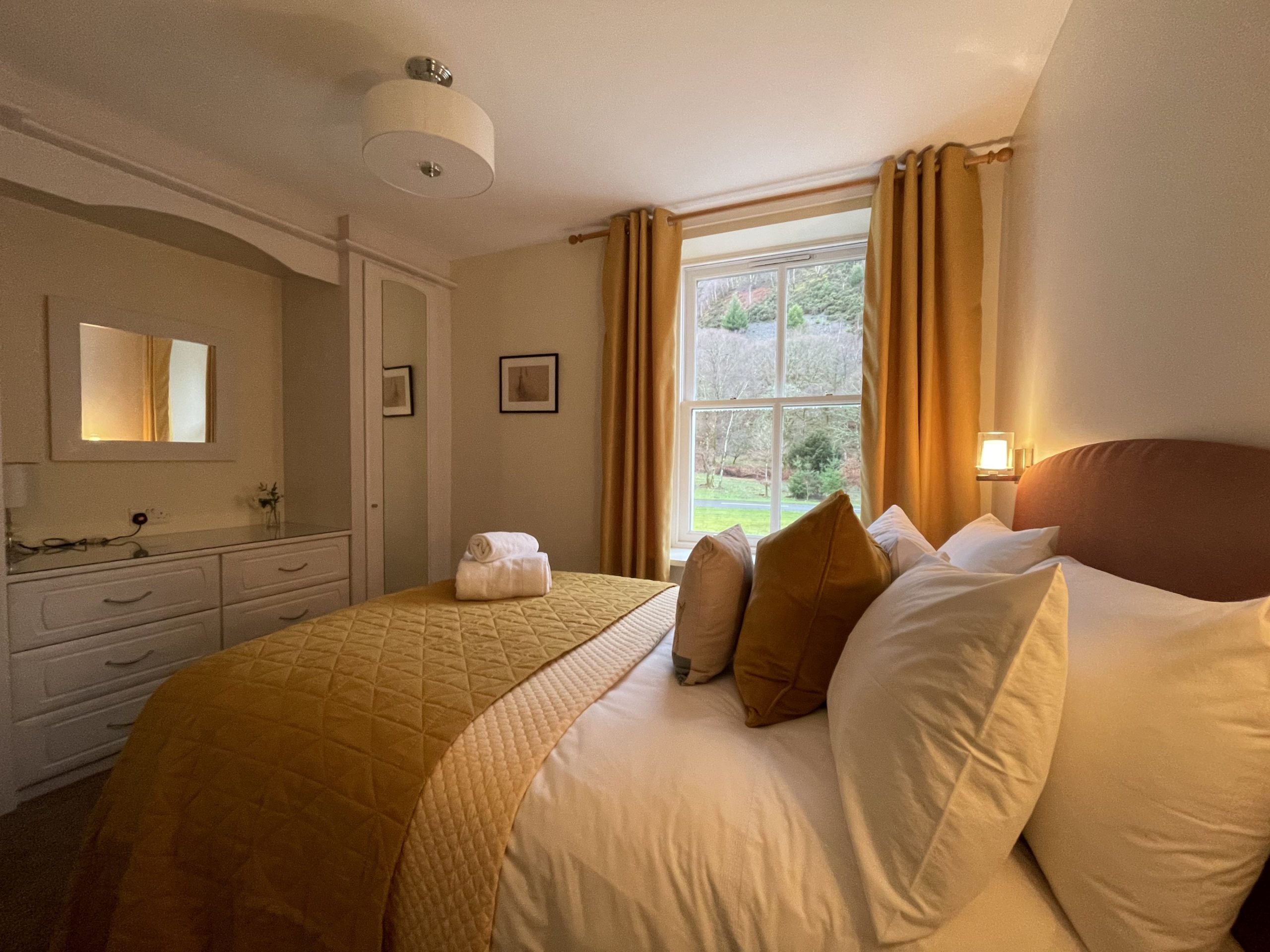 The second bedroom features a double bed and fitted cupboards