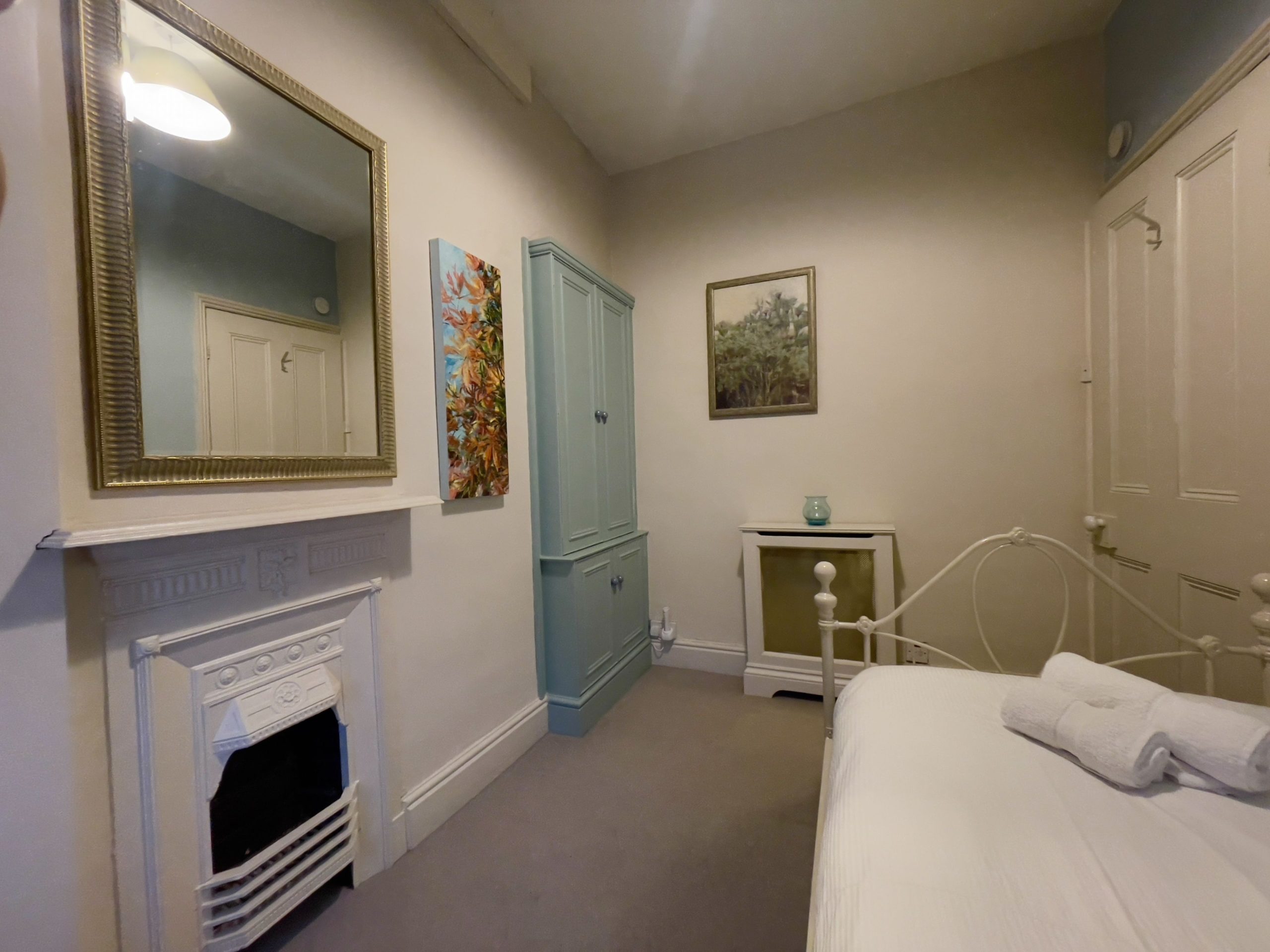 A fitted cupboard provides plenty of storage in the single bedroom