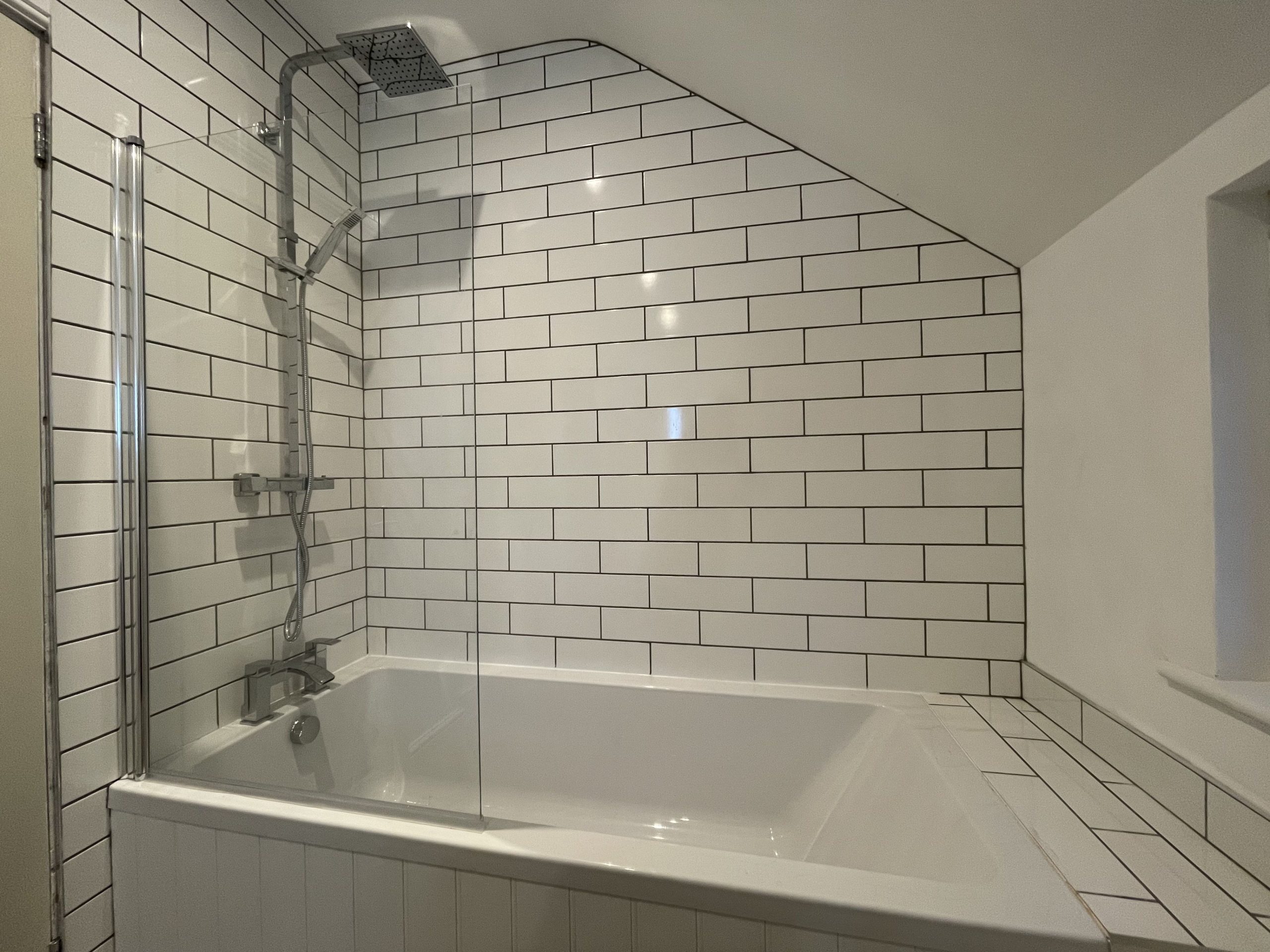 The bathroom comprises bath with overhead and hand held showers, WC, hand sink and heated towel rail