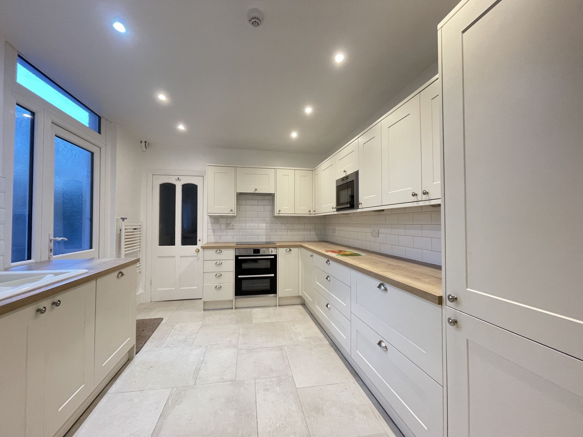 The large galley kitchen can be found at the rear of the property, and has a door to the patio area