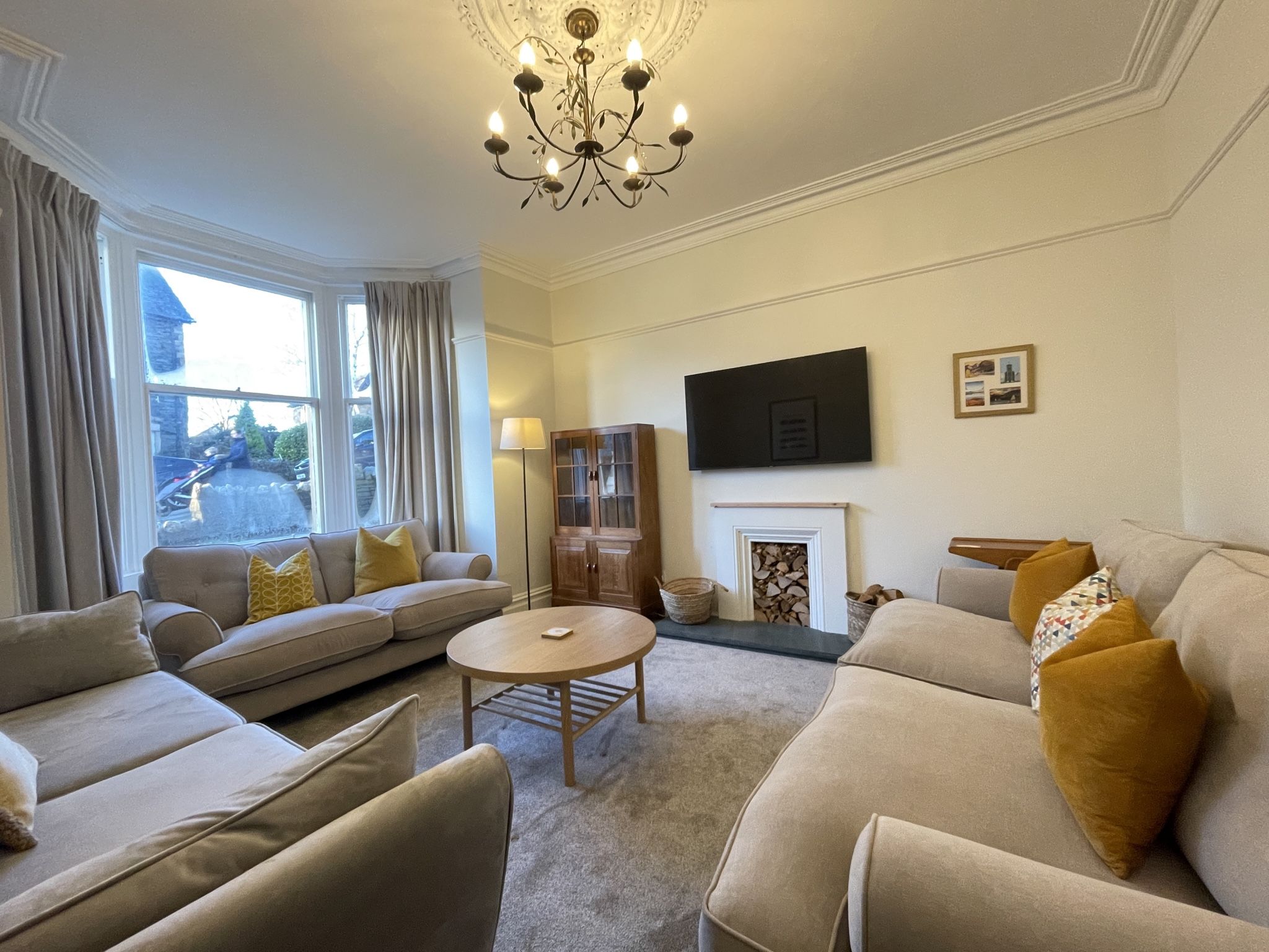 The front reception room features a beautiful bay window, decorative fireplace and high ceilings