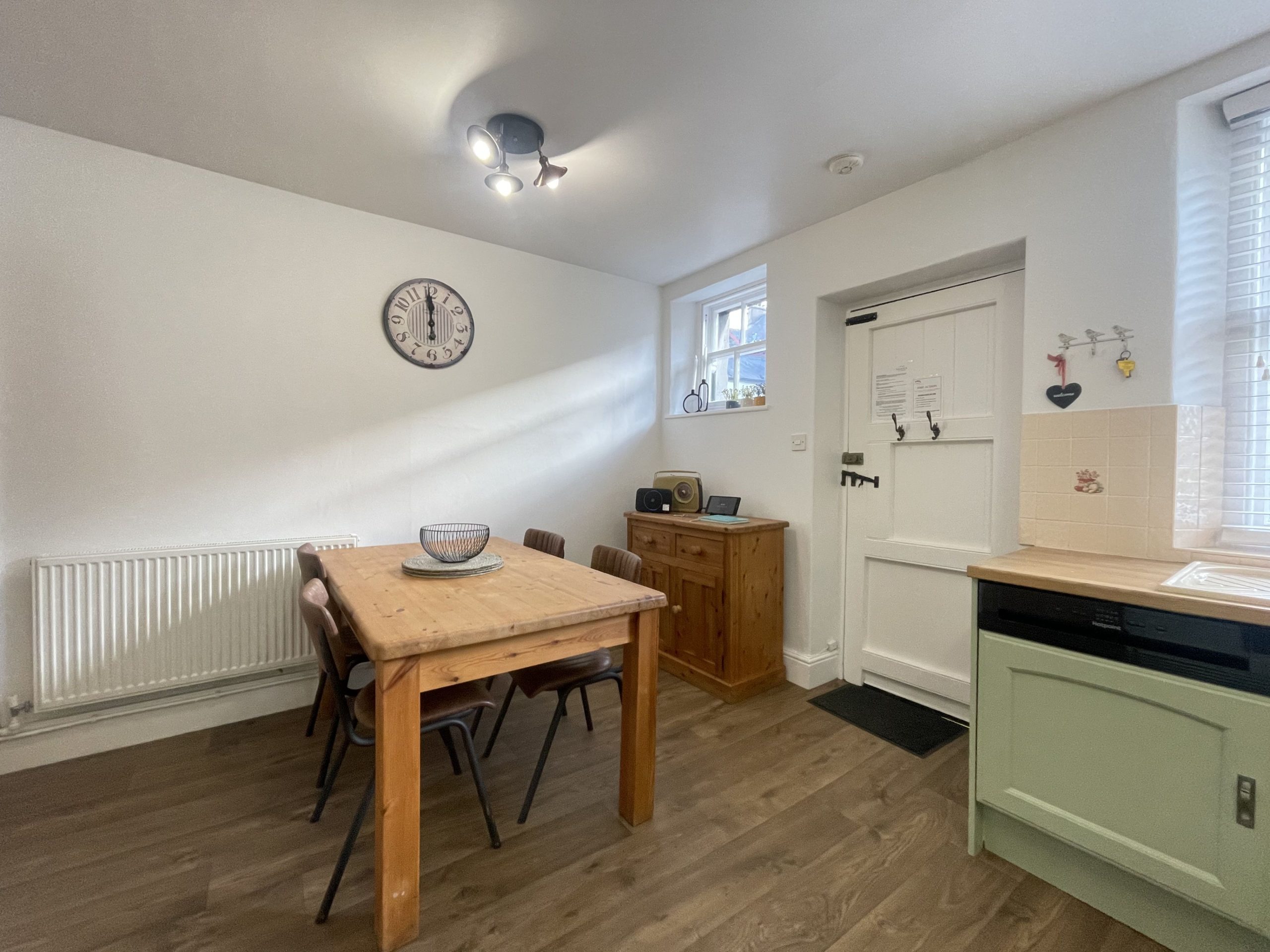 A farmhouse table and chairs complete this traditionally decorated room