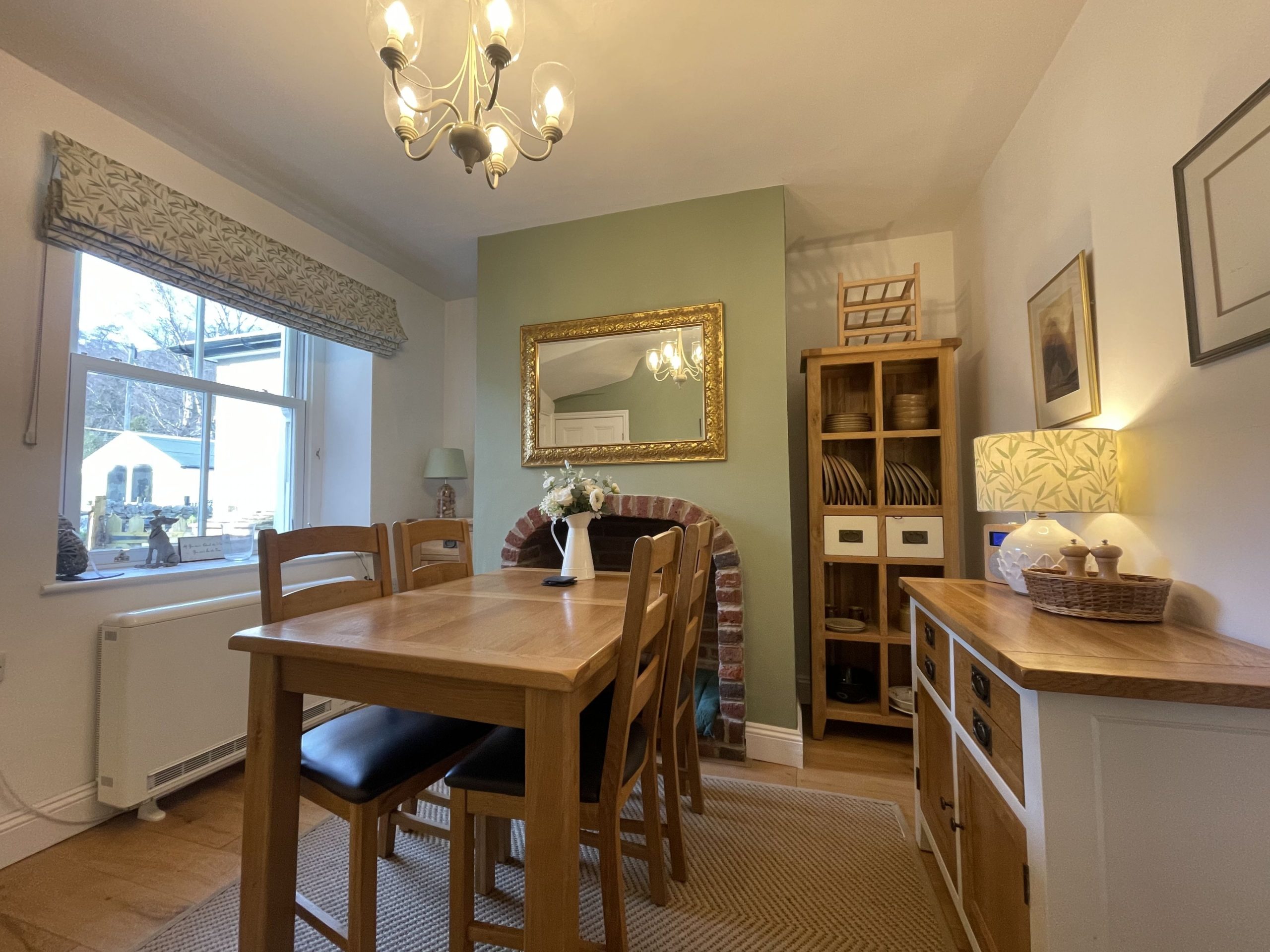 The middle room of the property is furnished with a dining table and drawers