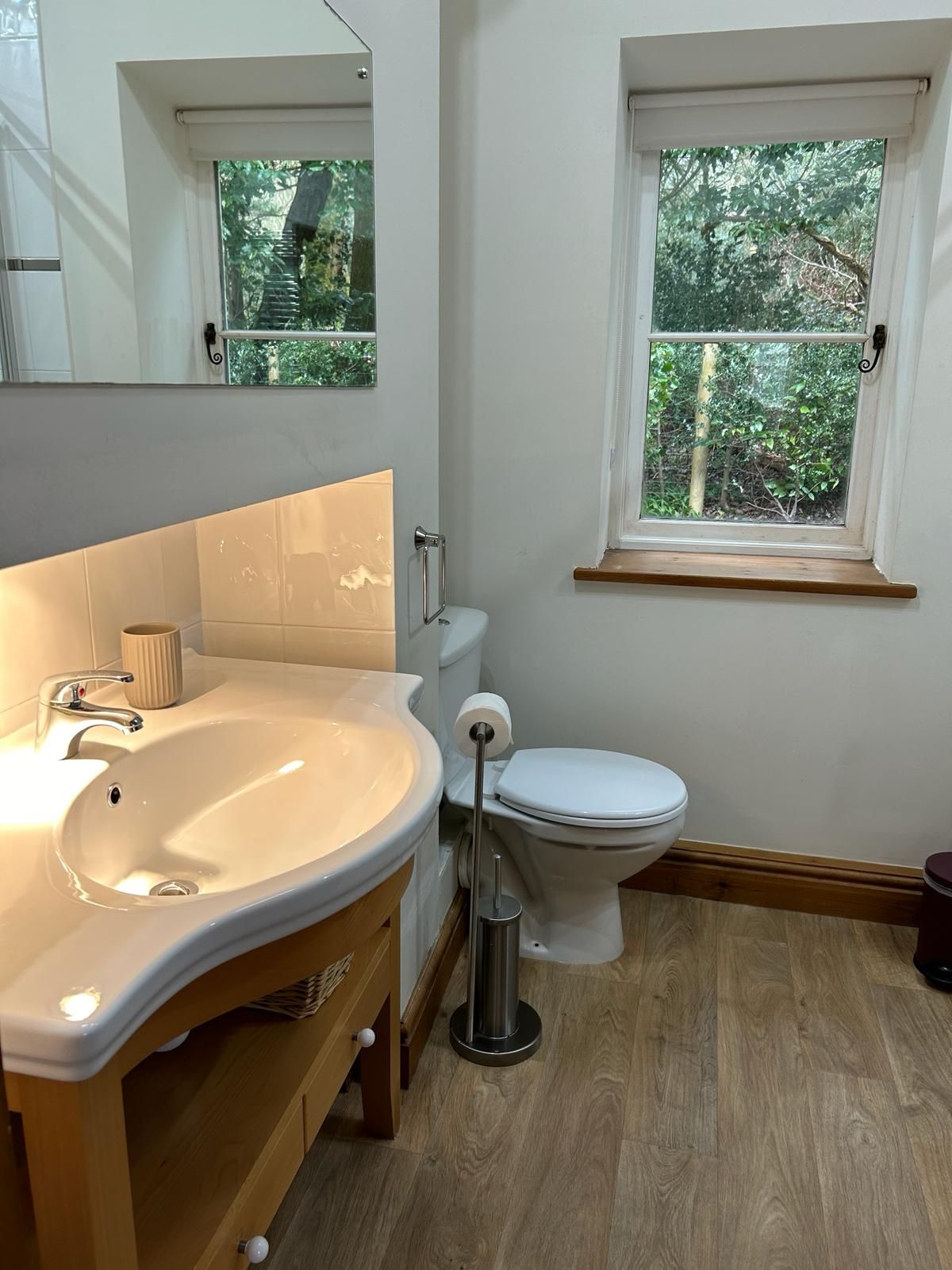 The bathroom has a bath with a shower over it, ideal for relaxing tired muscles after a day out