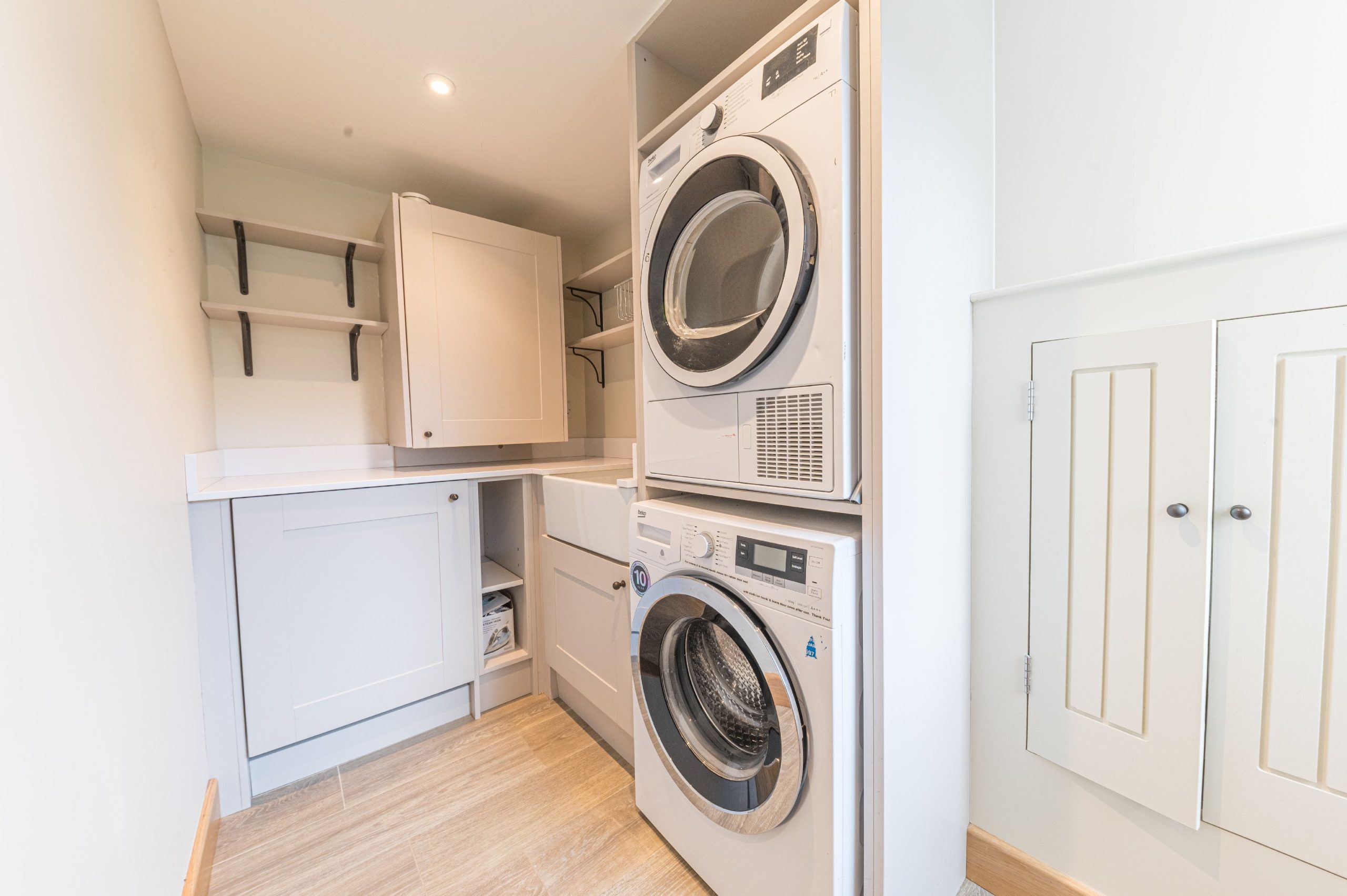 A handy utility area contains the washer and drier