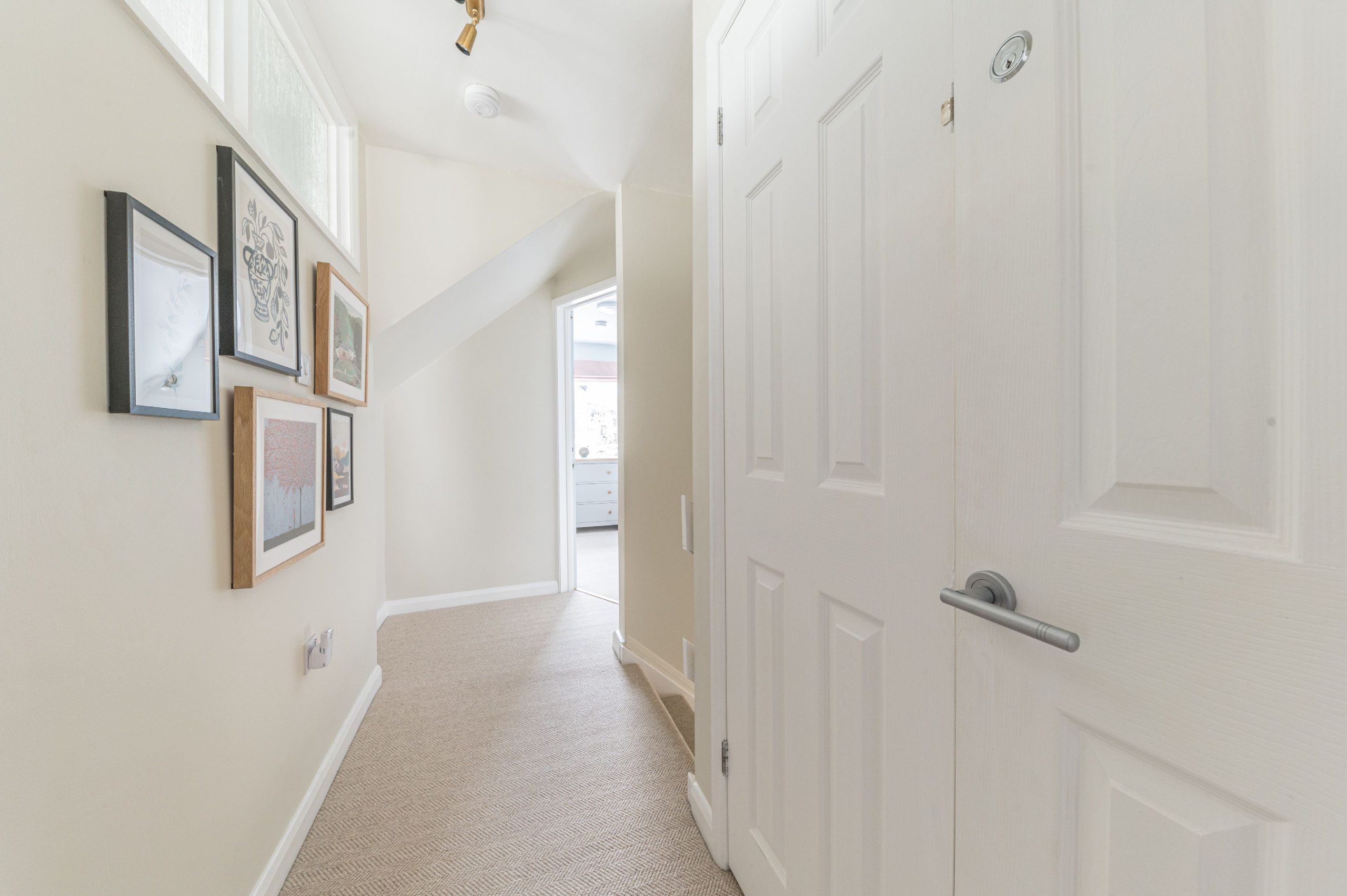 The upstairs hallway is lit by the internal windows from the bathroom