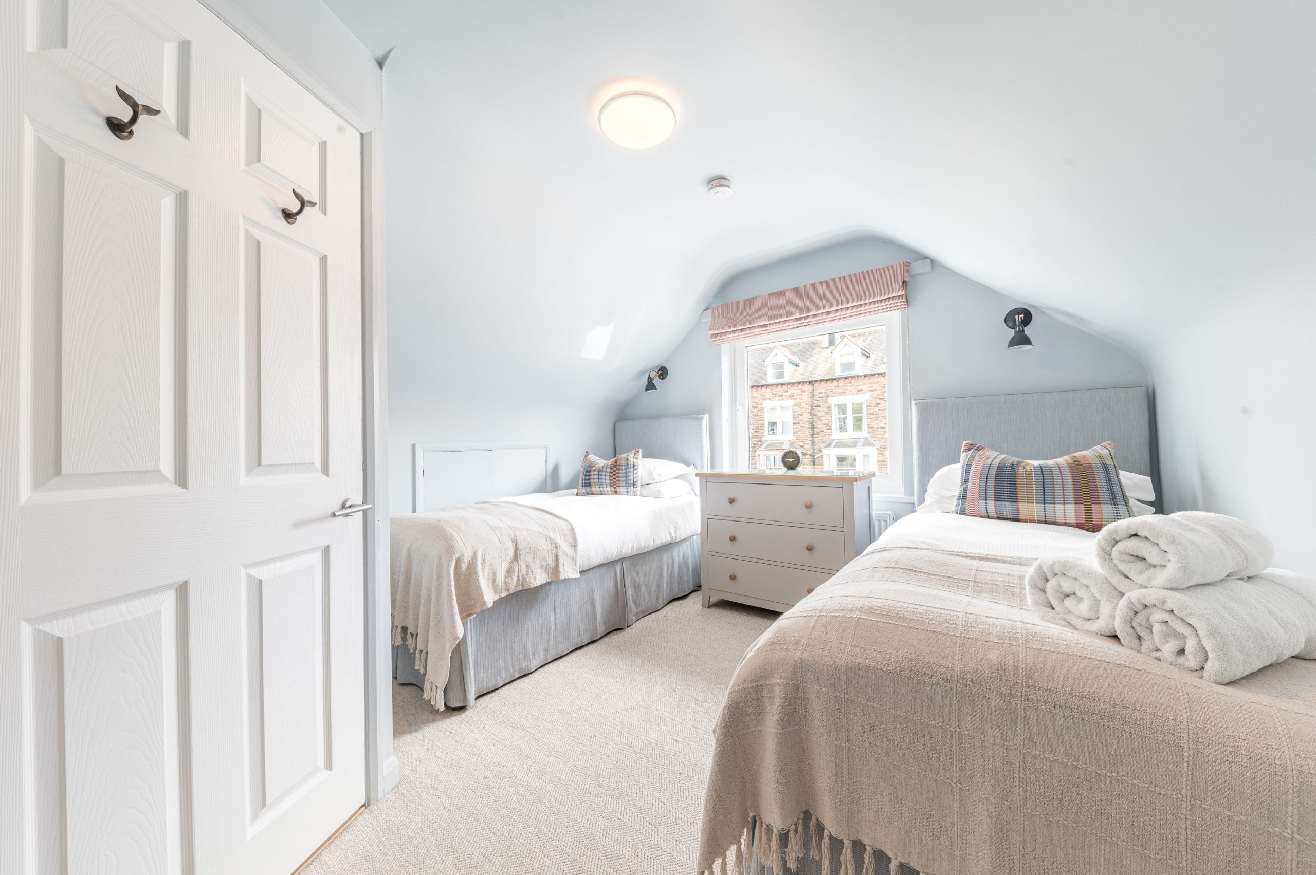 The room is furnished with 2 single beds, drawers and has hanging space for your clothes