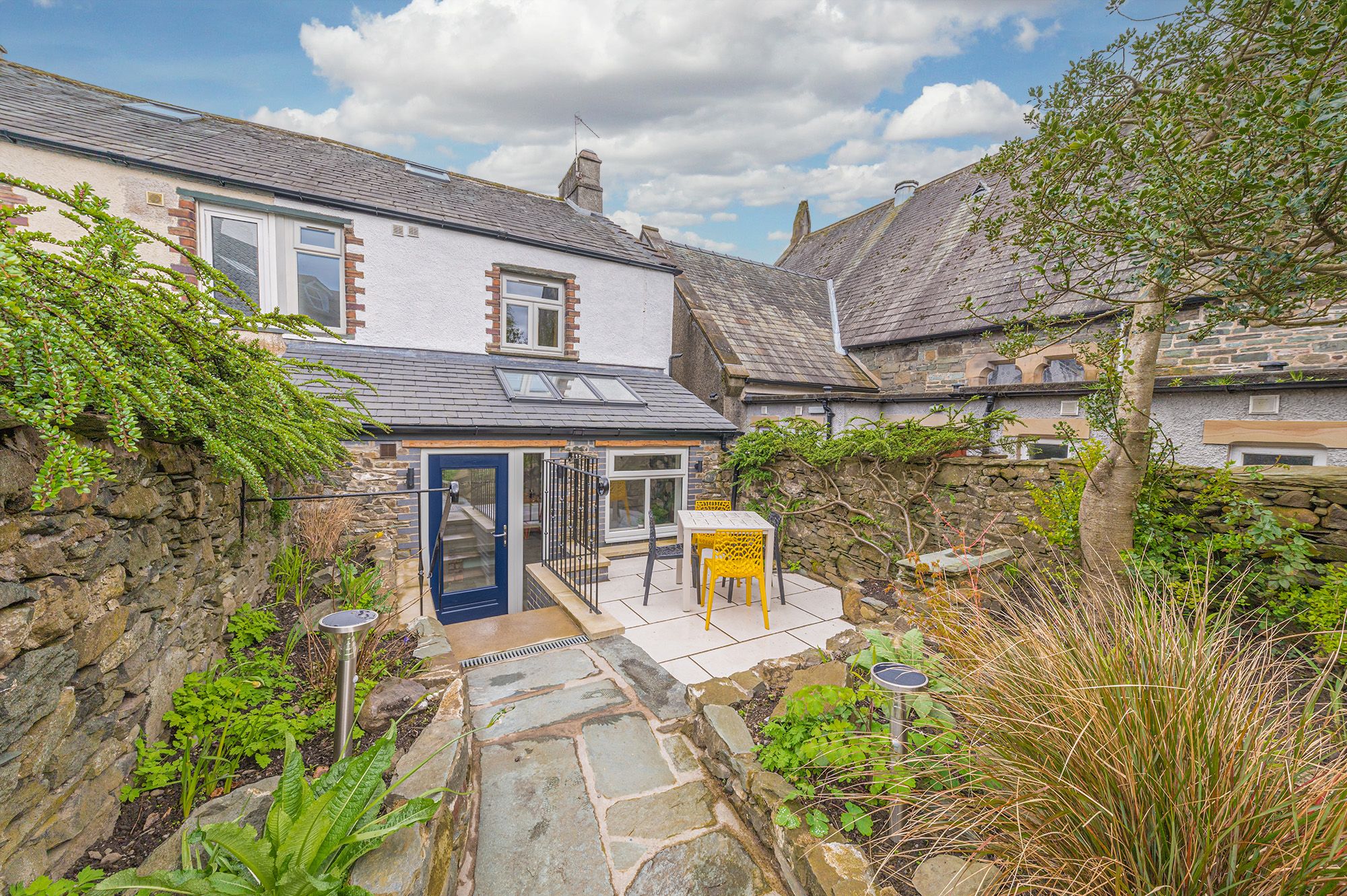 The pretty back garden has a patio area for outdoor dining