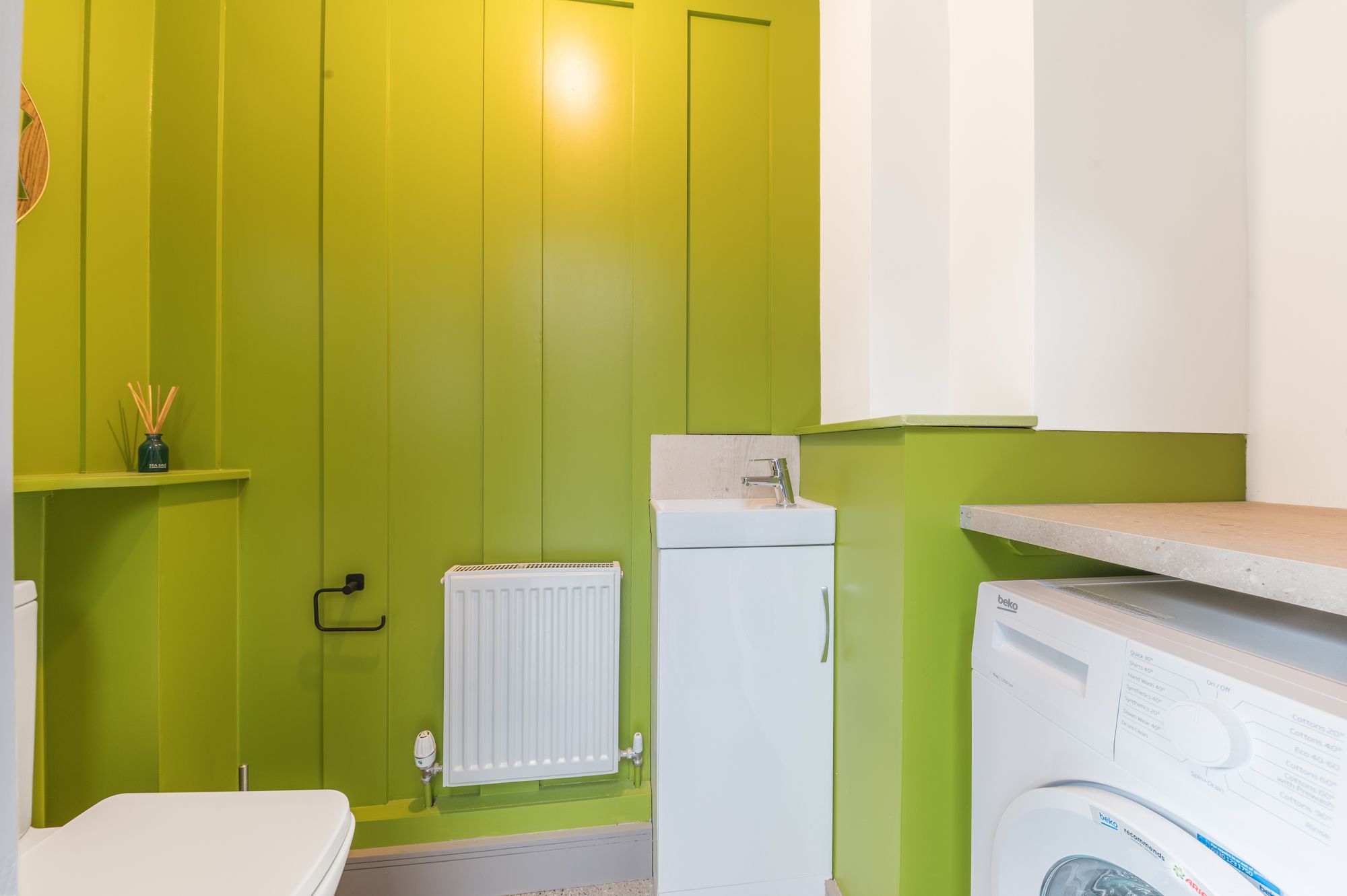 From the sun room you can enter the downstairs WC, which also houses the washing machine