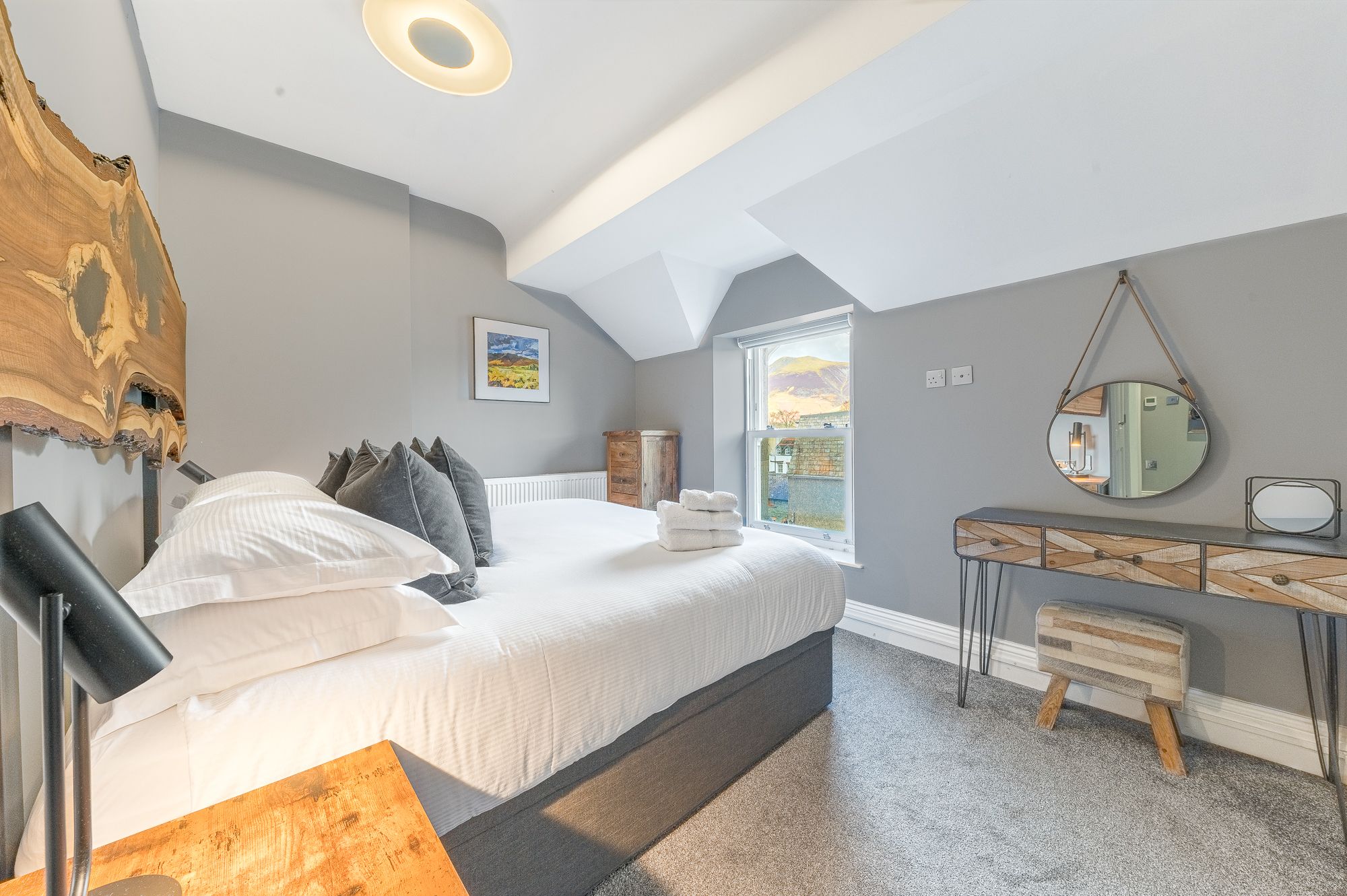 The bedroom also features a dressing table, bedside tables and a built in closet