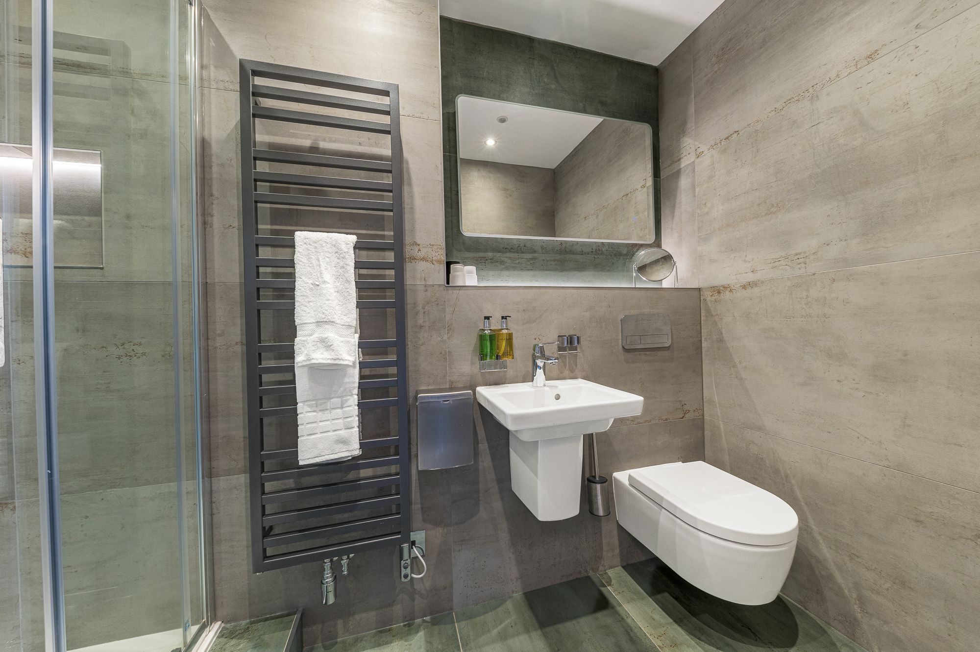 The ensuite comprises walk in shower, WC, hand sink and heated towel rail