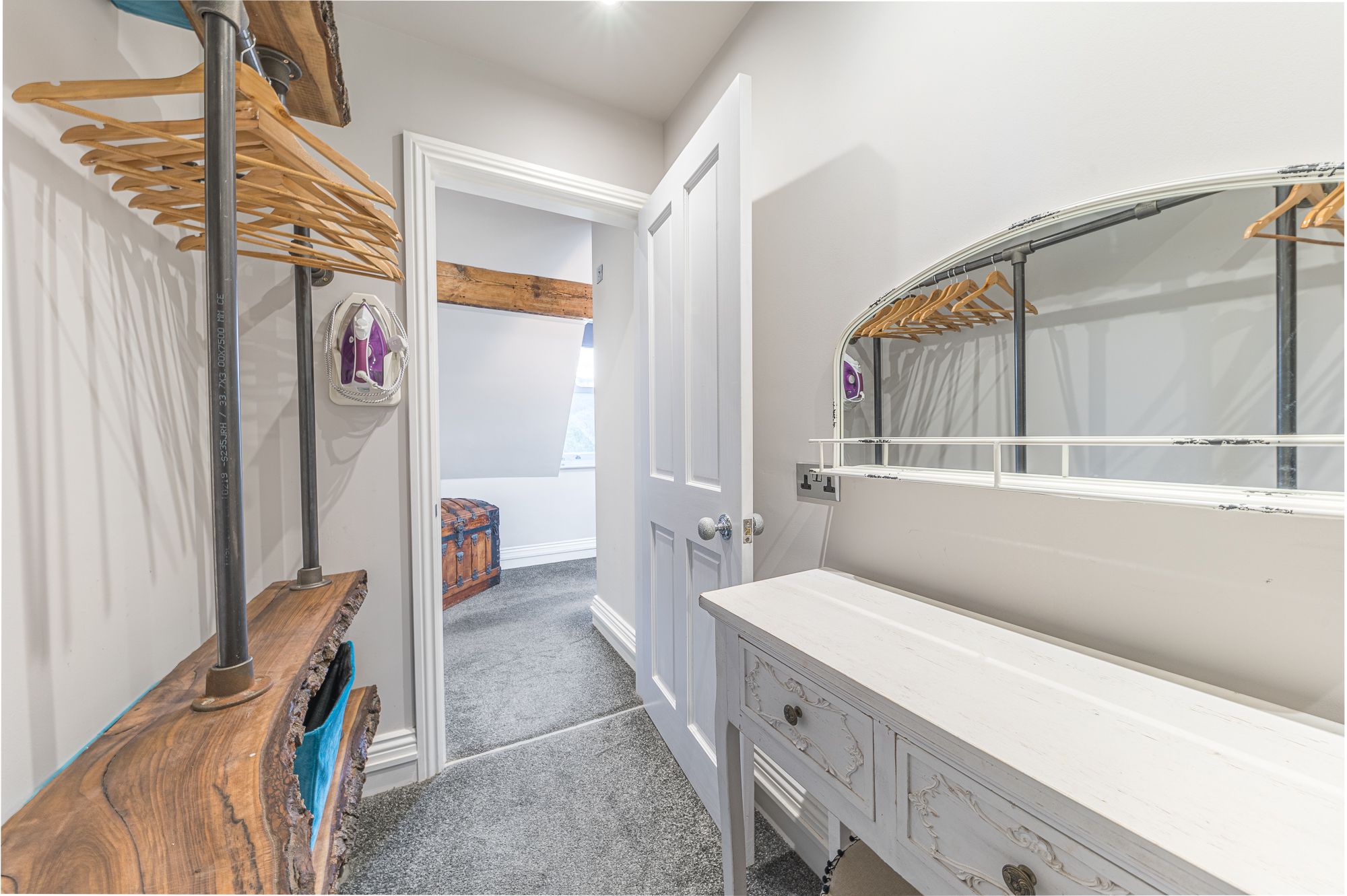 There is also a dressing table and mirror in the walk in wardrobe