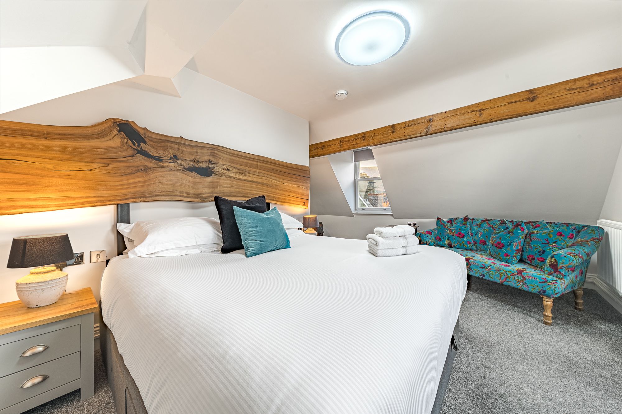 The master bedroom features a super-king sized bed, sofa and walk in wardrobe with dressing table
