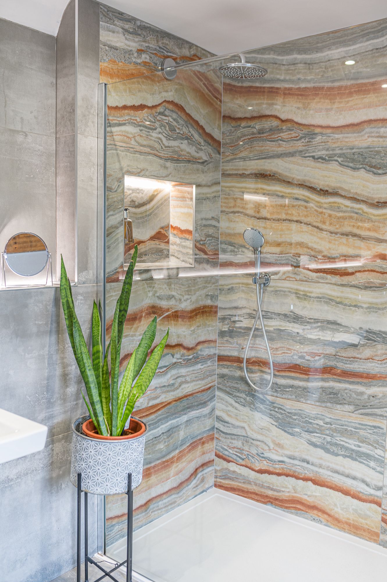 The walk in shower has both waterfall and hand-held shower heads