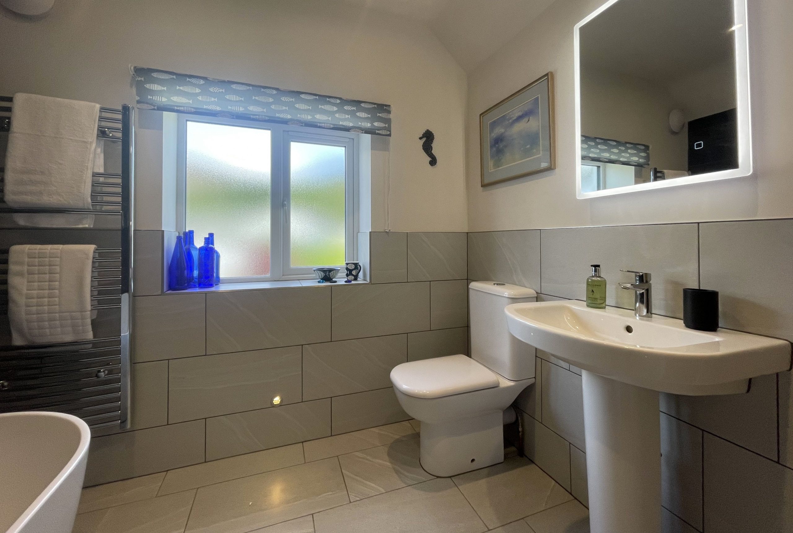 The bathroom is spacious and full of light