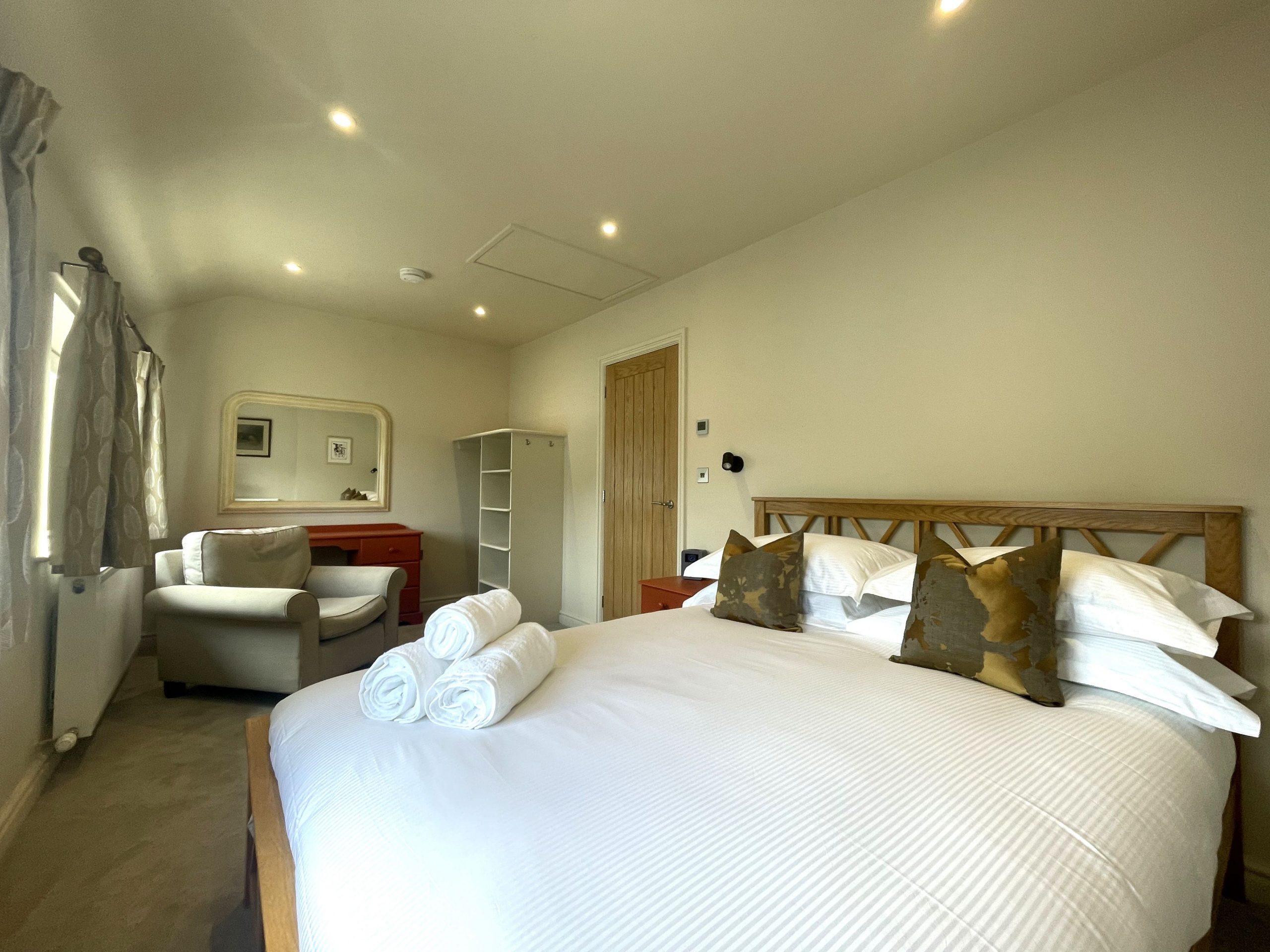 A lovely master bedroom has plenty of storage and a dressing table