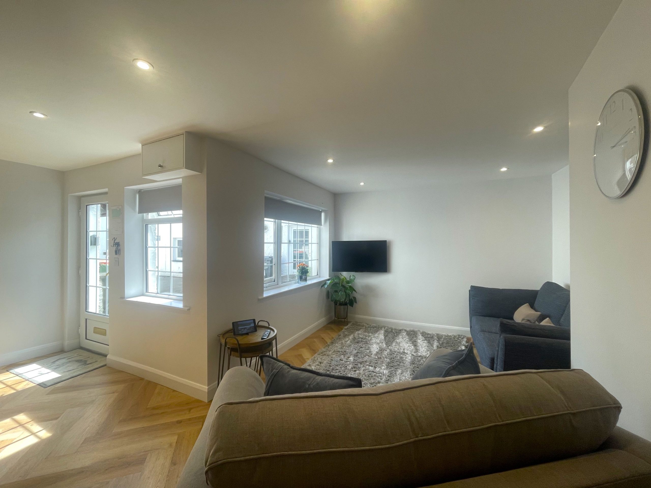 The living room has a wall mounted smart TV for cosy nights in