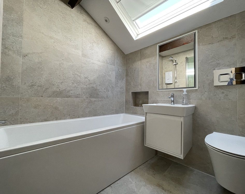 The master ensuite comprises a bath with overhead shower