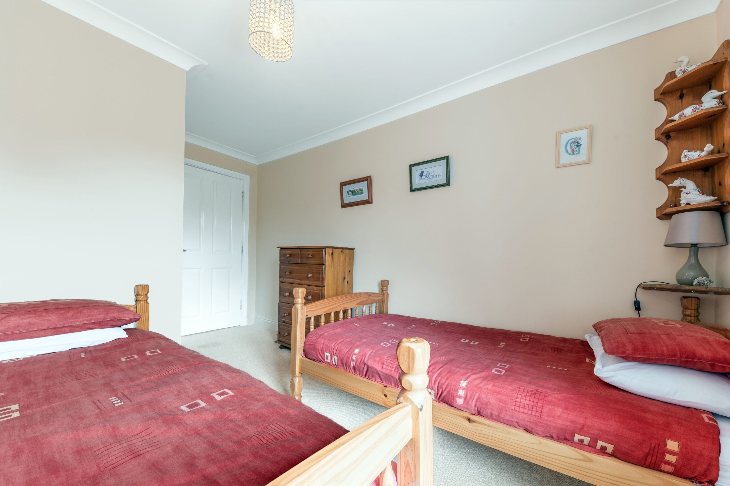 The twin bedroom features 2 single beds, built in closet and drawers