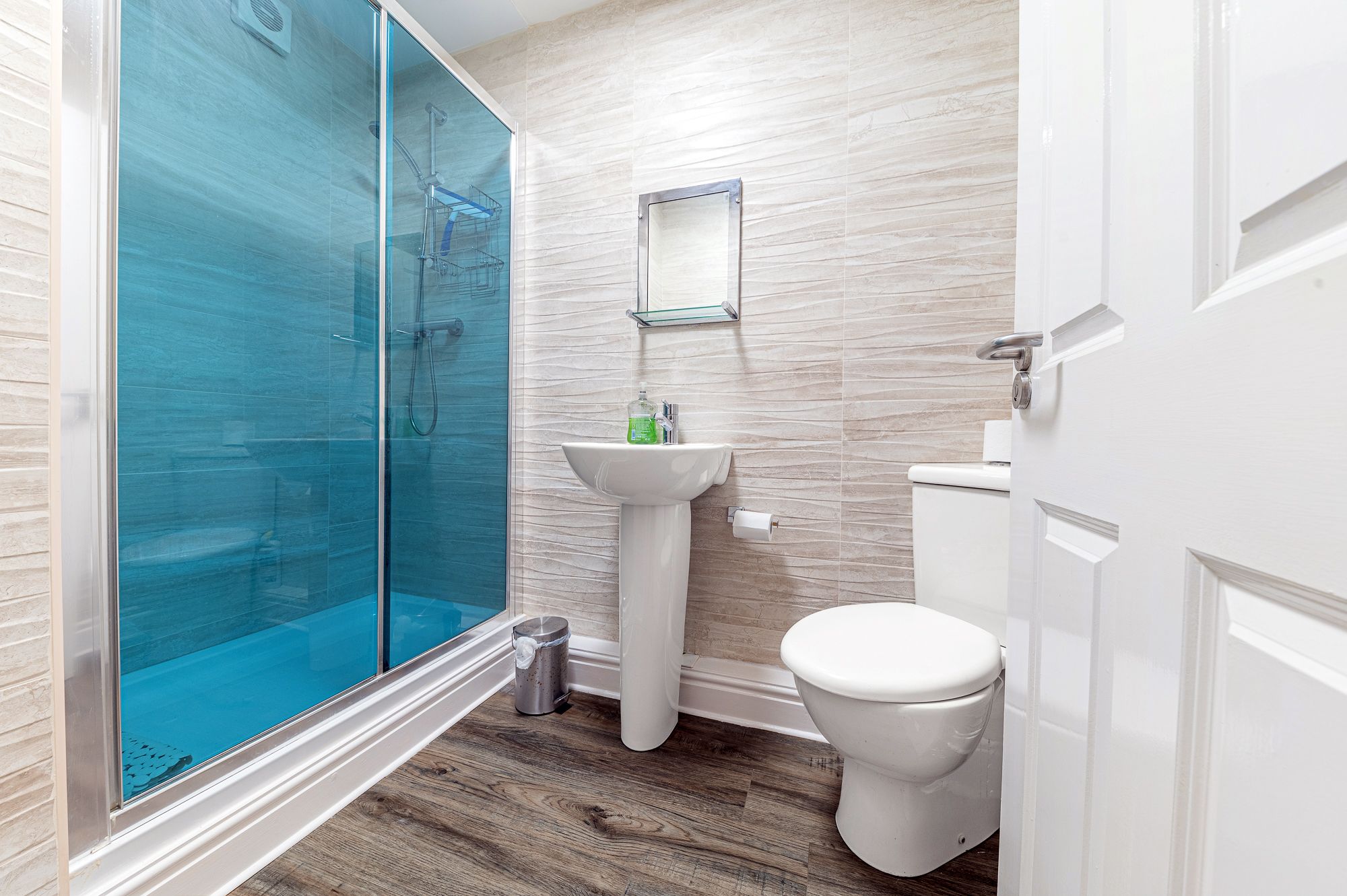 The ensuite bathroom comprises a walk in shower, WC and hand basin