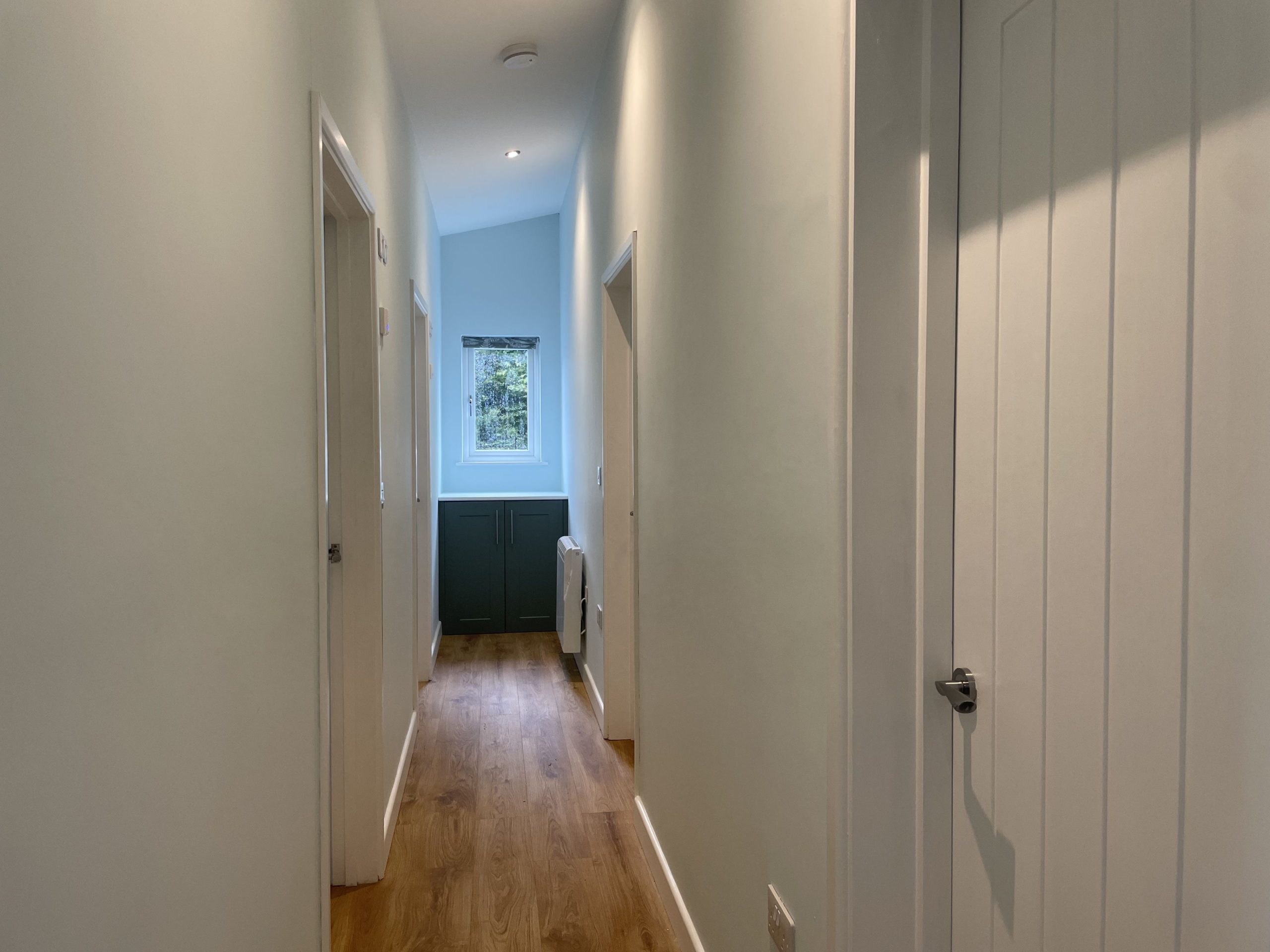 Bedrooms and bathrooms can be found off the corridor from the open plan living area