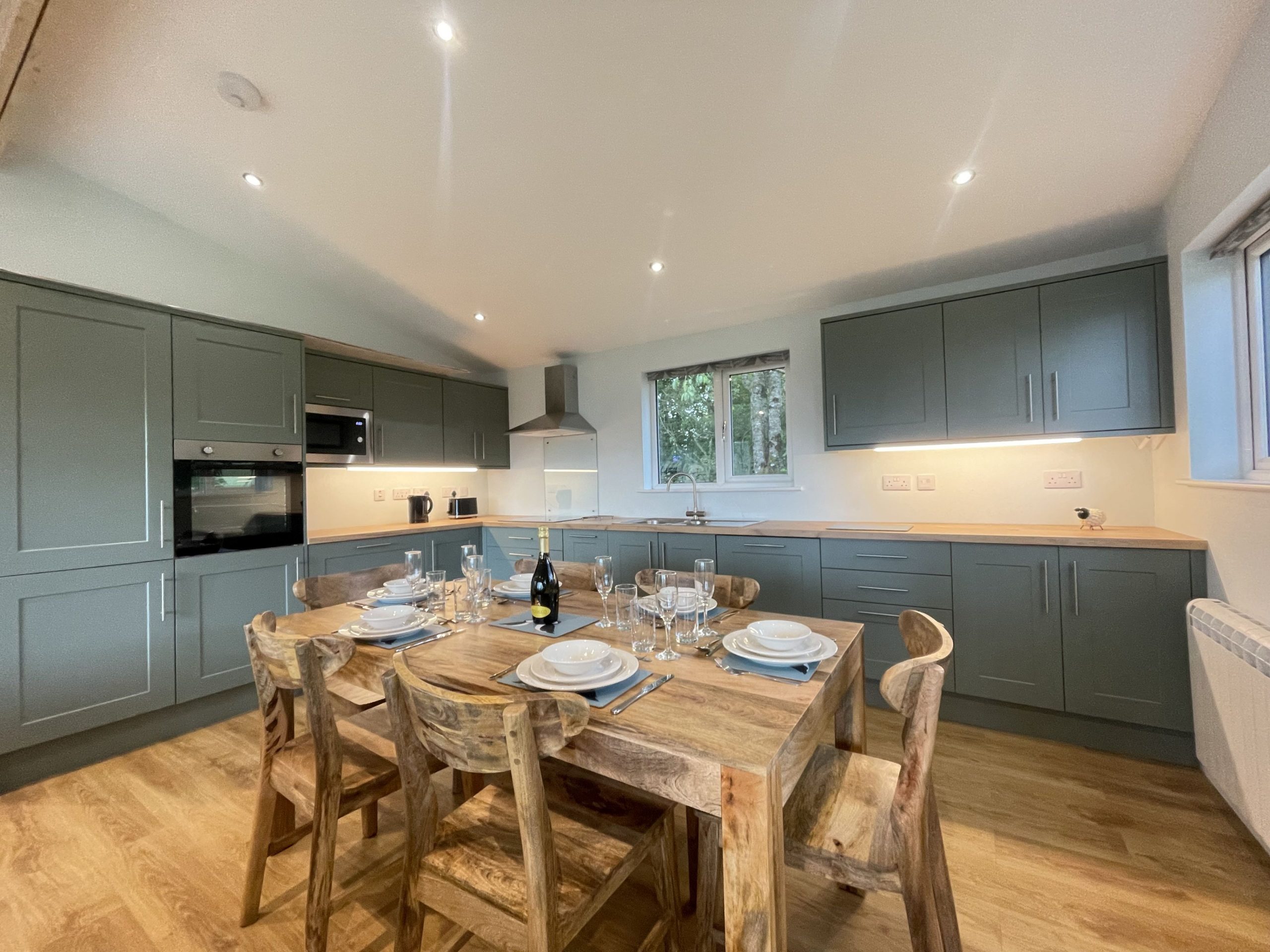 The modern kitchen is equipped with dishwasher, microwave, fridge/freezer, oven and electric hob