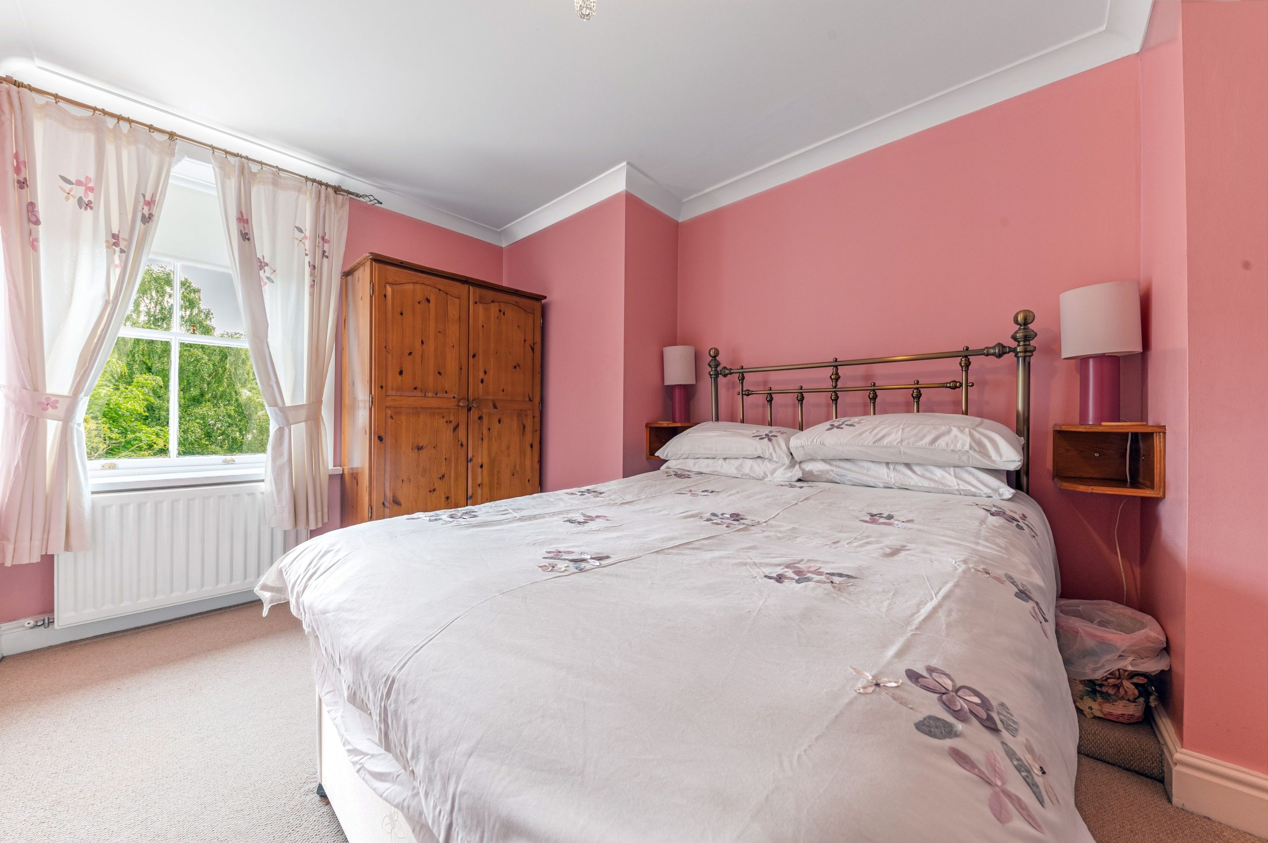 A further bedroom with double bed, wardrobe and chest of drawers